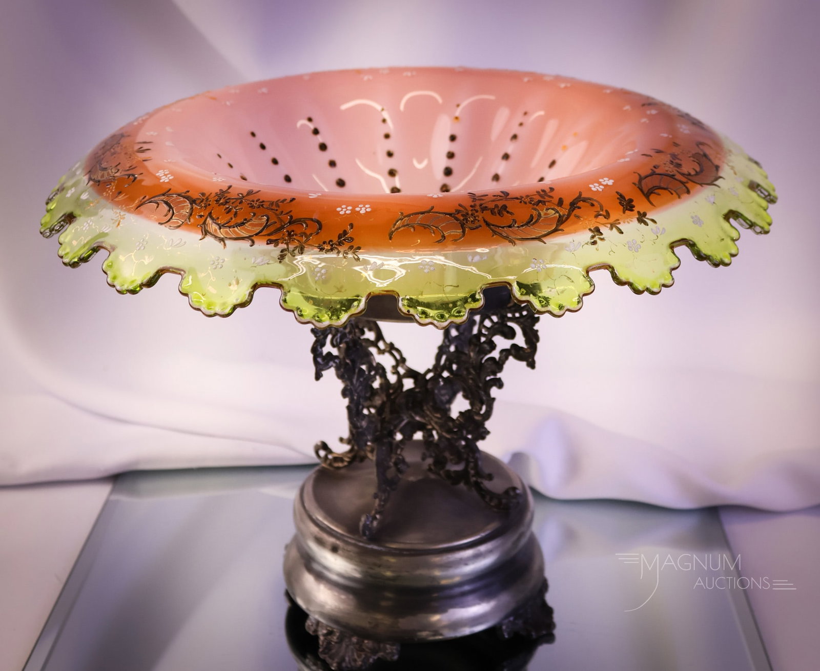 Van Bergh Victorian Silverplate Uranium Enameled Glass Cut Brides Bowl Centerpiece: A beautiful, uranium-rich Victorian pedestal brides' bowl centerpiece. This piece features a Van Bergh marked silverplate holder and a salmon to yellow colored enamel decorated art glass bowl. The bow