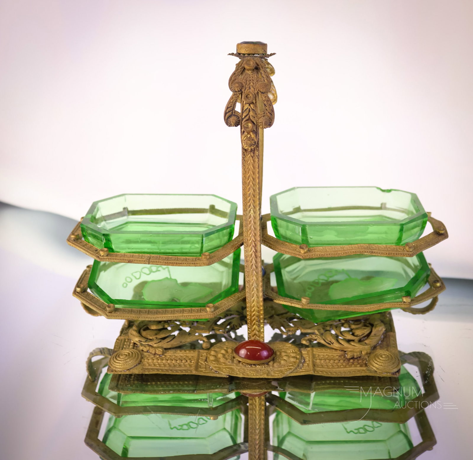 Czech Jeweled Frame Uranium Green Intaglio Glass Open Salts Set: A beautiful find in a set of open salts, complete with its carrier frame. This fine set has a Czech jeweled frame and four green uranium-rich open salts cut with an intaglio design. The set measures 4