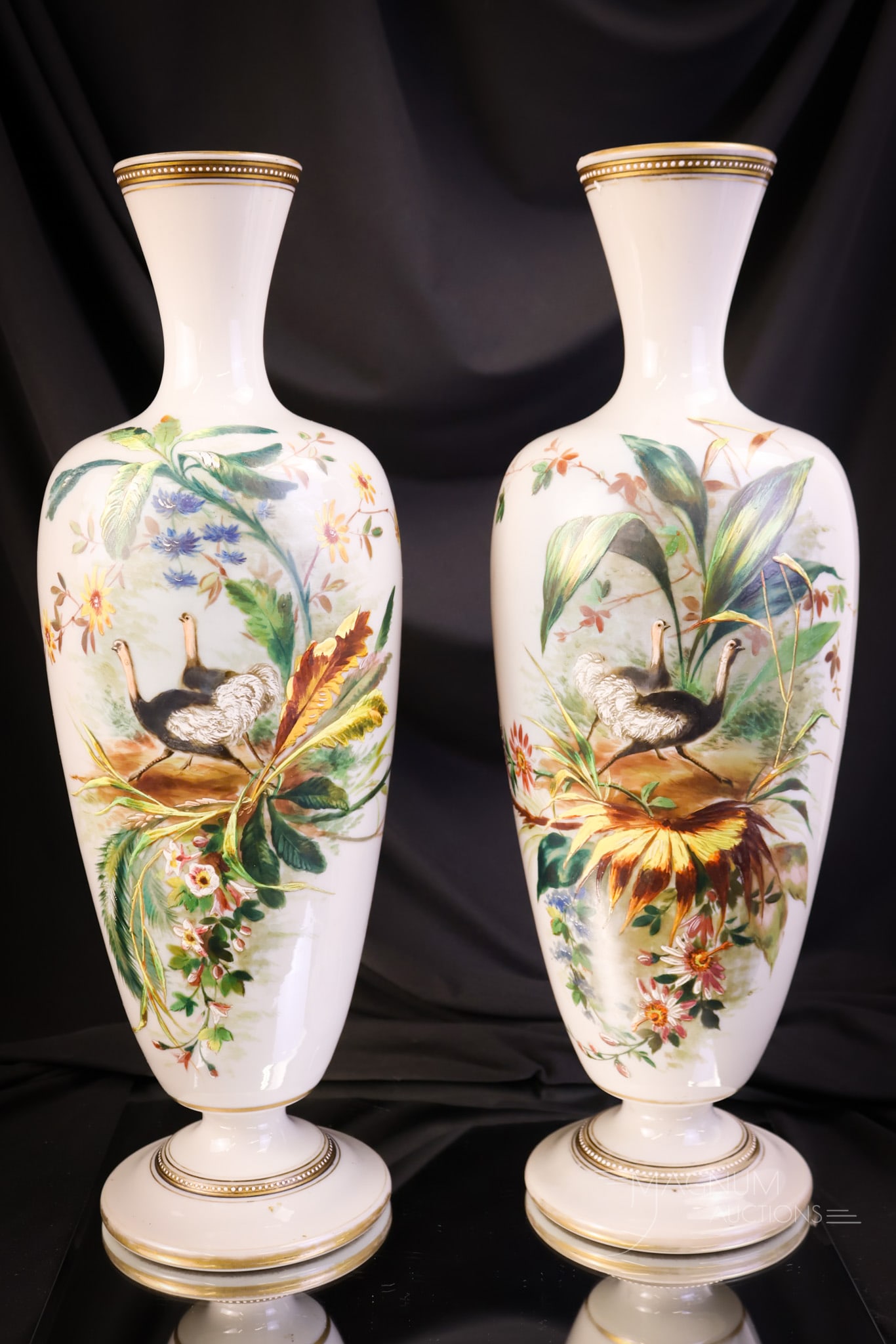 Pair of Monumental 16 1/4" Victorian Enameled Glass Ostrich Opposing Vases: A monumental find in decorated enameled glass Victorian vases. This pair is in a deep dove grey with opposing enameled scenes of ostriches and tropical foliage. Each measures 16 1/4" tall and 5" wide.