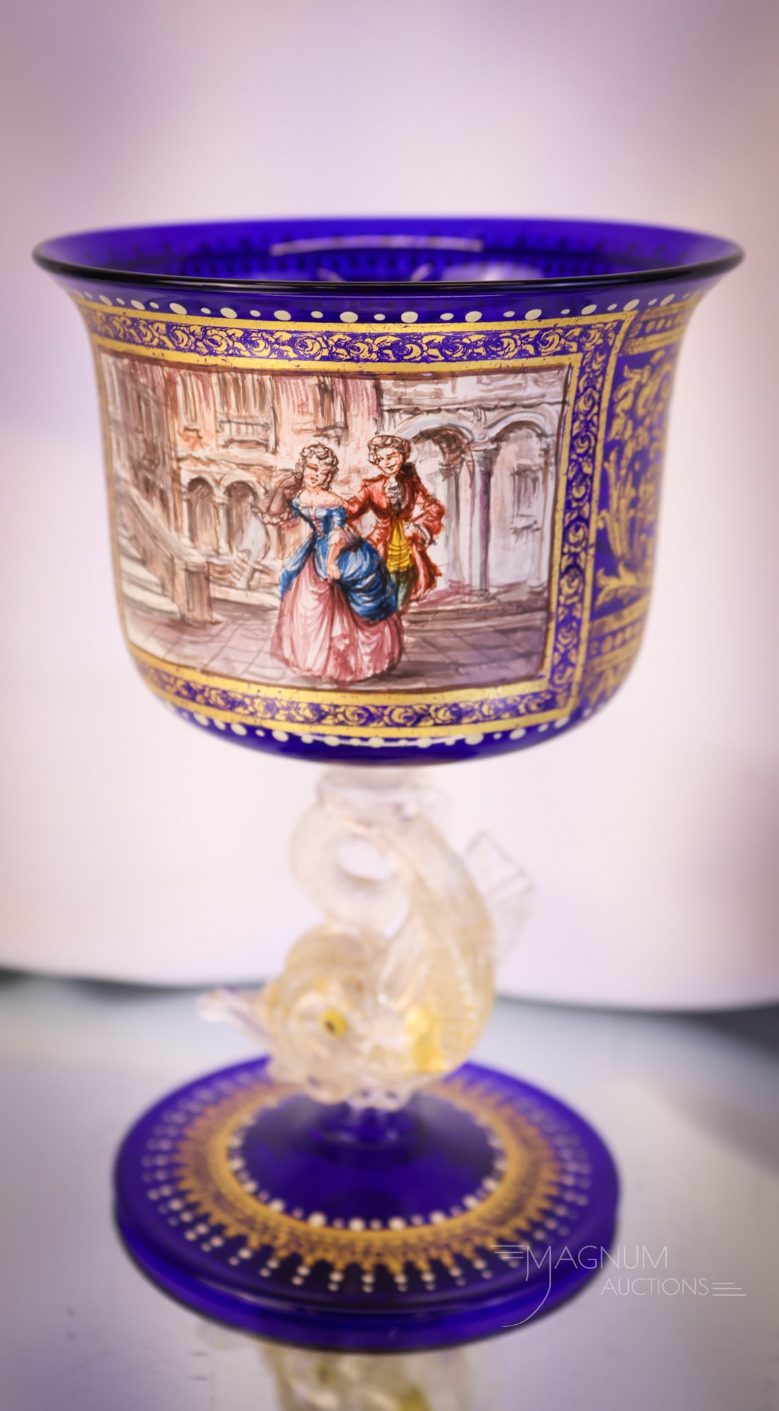 Venetian Art Glass Dolphin Stem Courting Scene Goblet: A great find for your collection. This is a Venetian dolphin-stemmed goblet featuring a courting scene. The goblet is in cobalt glass. It measures 6" tall and 4" wide. SHIPPING NOTICE: If you choose n