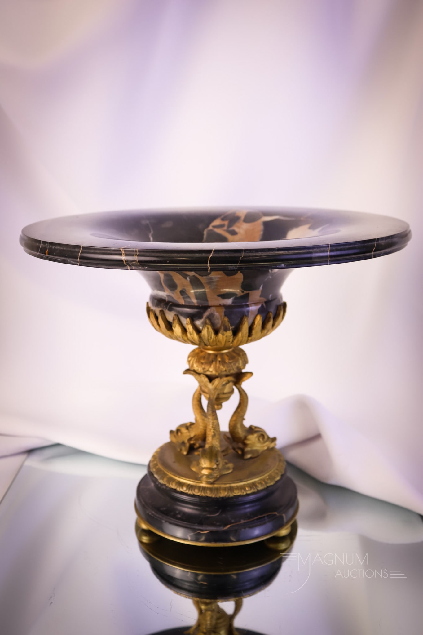 French Bronze & Marble Triple Dolphin Pedestal tazza: A select offering of a French bronze and marble pedestal tazza. This piece features a triple dolphin stem. It bears a made in France mark. The tazza measures 9" tall and 10 1/2" wide. SHIPPING NOTICE: