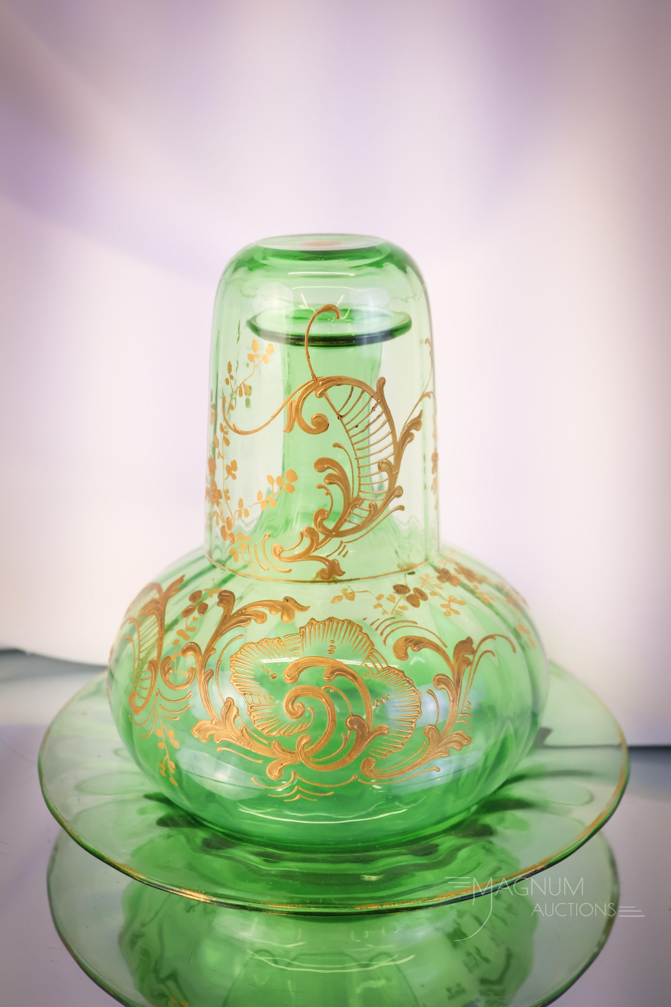 Moser Basil Green Antique Gilt Decorated Glass Tumble-Up Night Set: A fine piece for any collection. This is a Moser tumble-up or night set in basil green glass with gilt decoration. The three-piece set includes the tumbler, carafe, and the underplate. The set measure