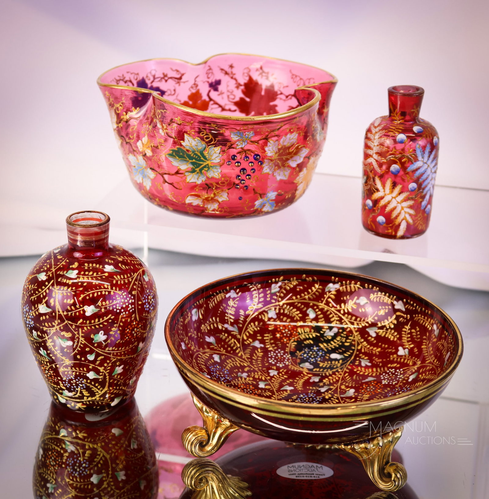 4 pc Lot Moser Cranberry Glass: Four delights for your collecting habit. This lot includes a three-footed dish, a perfume bottle, a miniature vase, and, lastly, a finger bowl. The finger bowl is decorated with cabochon grape cluster
