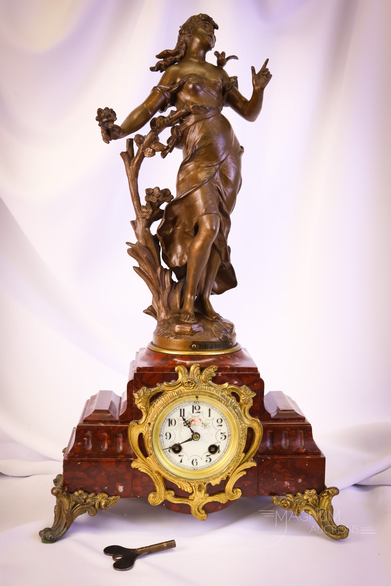 Antique 22 1/2" August Moreau Bronze Figural Art Nouveau Mantle Clock: A beautiful find in an antique figural mantle clock. This piece is signed August Moreau and features an Art Nouveau lady and a marble-clad case. The clock also has ormolu feet and a porcelain clock fa