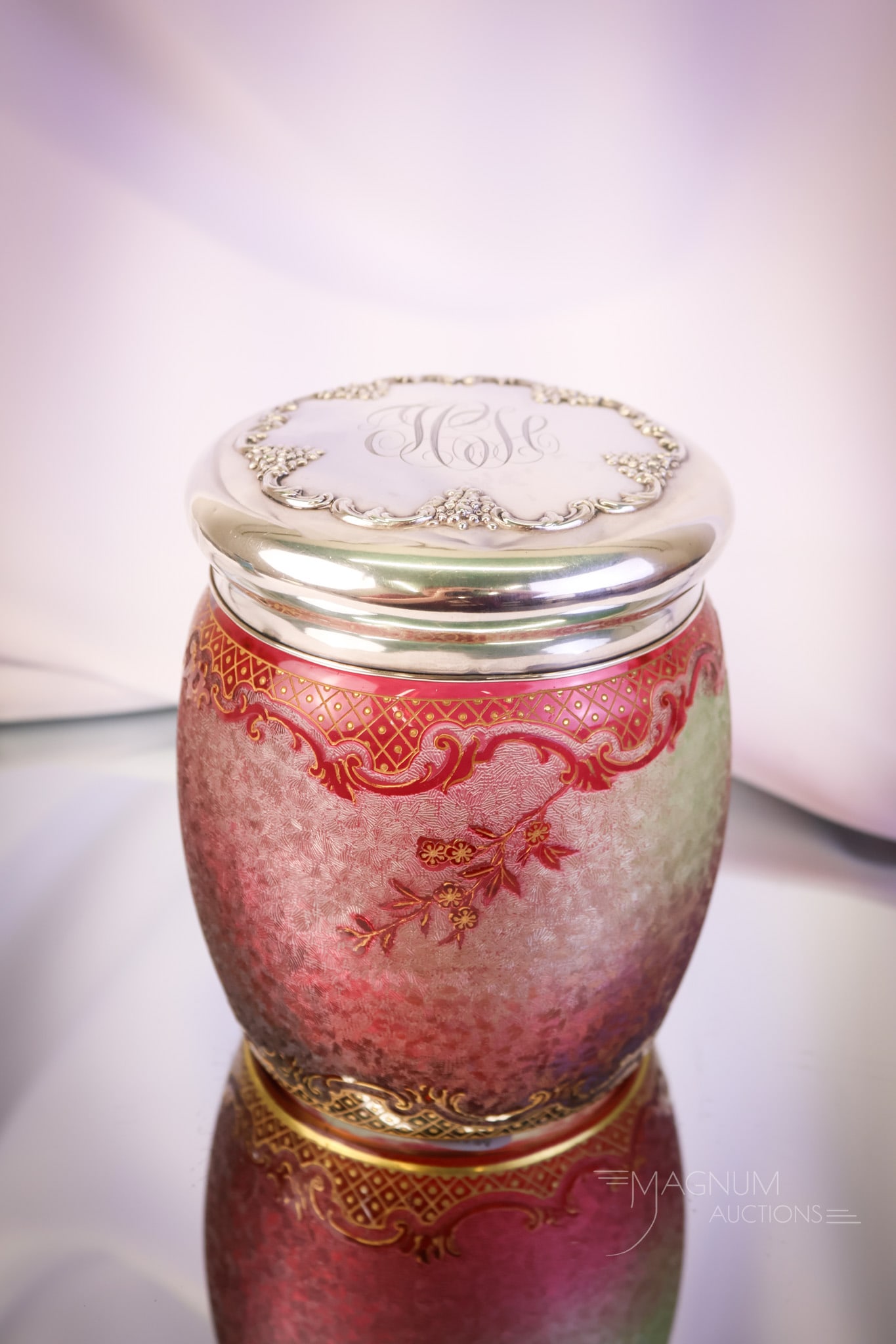 Baccarat Acid Etched Cameo Cranberry Uranium Glass & Sterling Repousse Humidor: What a lovely find this piece of Baccarat is! This is a humidor in acid-etched cameo glass. The jar is cranberry-colored with floral and scrolling motifs in the design. It is rich in uranium and glows
