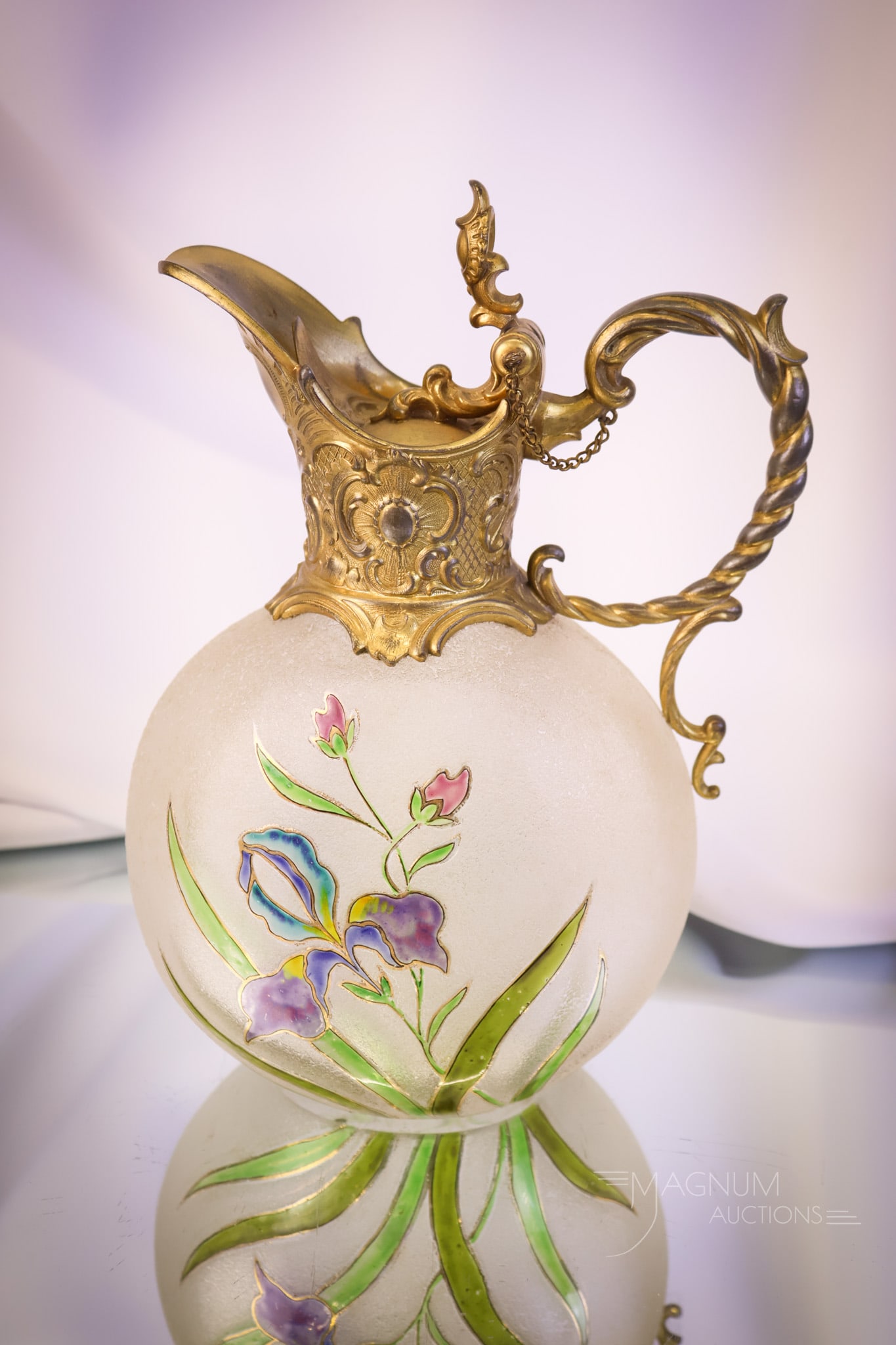 Legras Mt Joye Acid Etched Cameo Art Glass Claret Jug: A gorgeous Legras Mt. Joye attributed acid-etched cameo art glass claret jug. This piece features a gold-toned metal handle and spout. It is decorated with a colored iris and foliage. The claret measu
