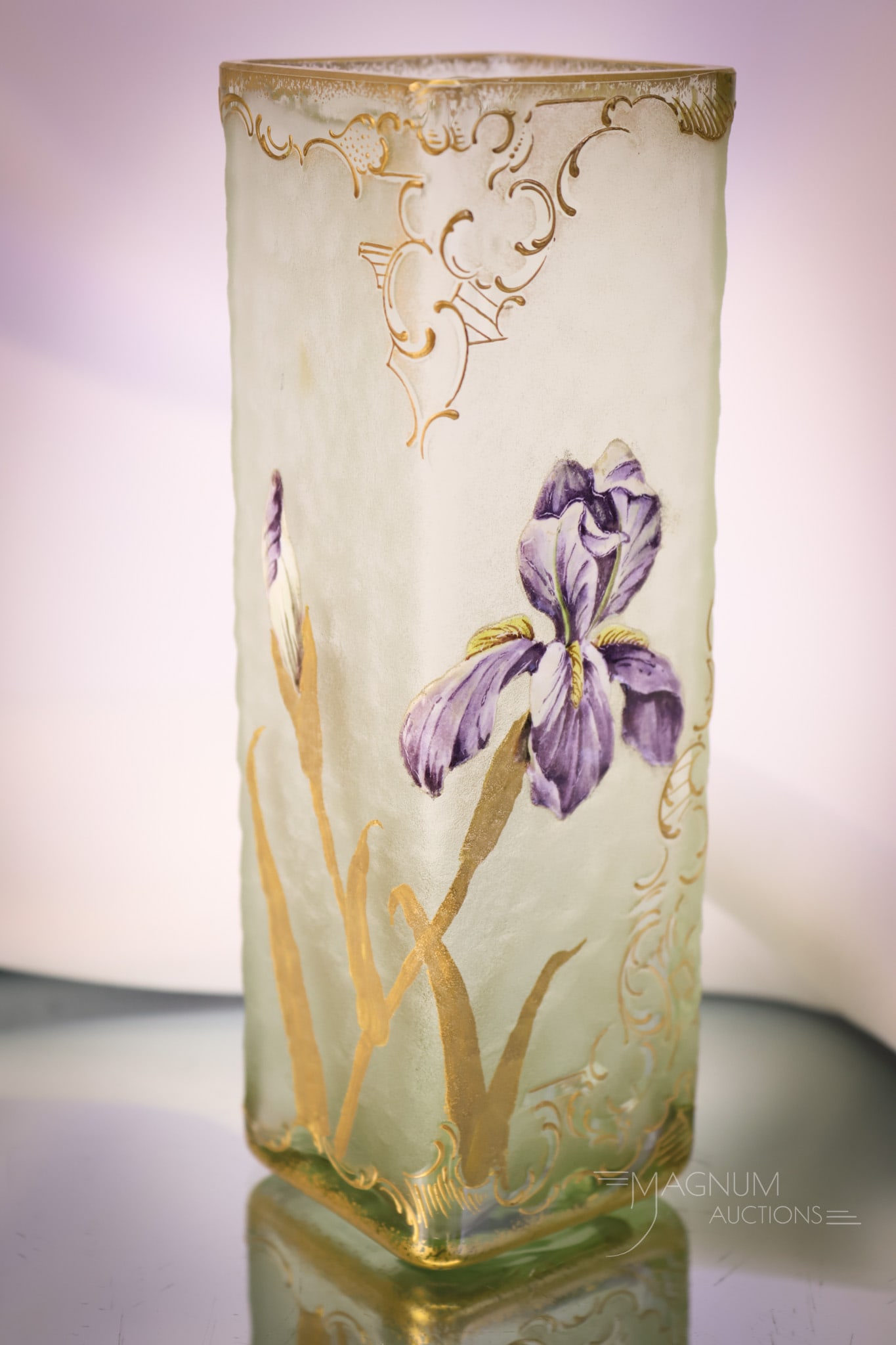 Legras Mt. Joye Acid Cut Cameo Enameled Art Glass Vase: A fine acid-cut cameo glass enameled vase attributed to Legras or Mt. Joye. This piece features a green color of the glass with a purple iris flower and gilt decoration. The vase measures 6 3/4" tall 