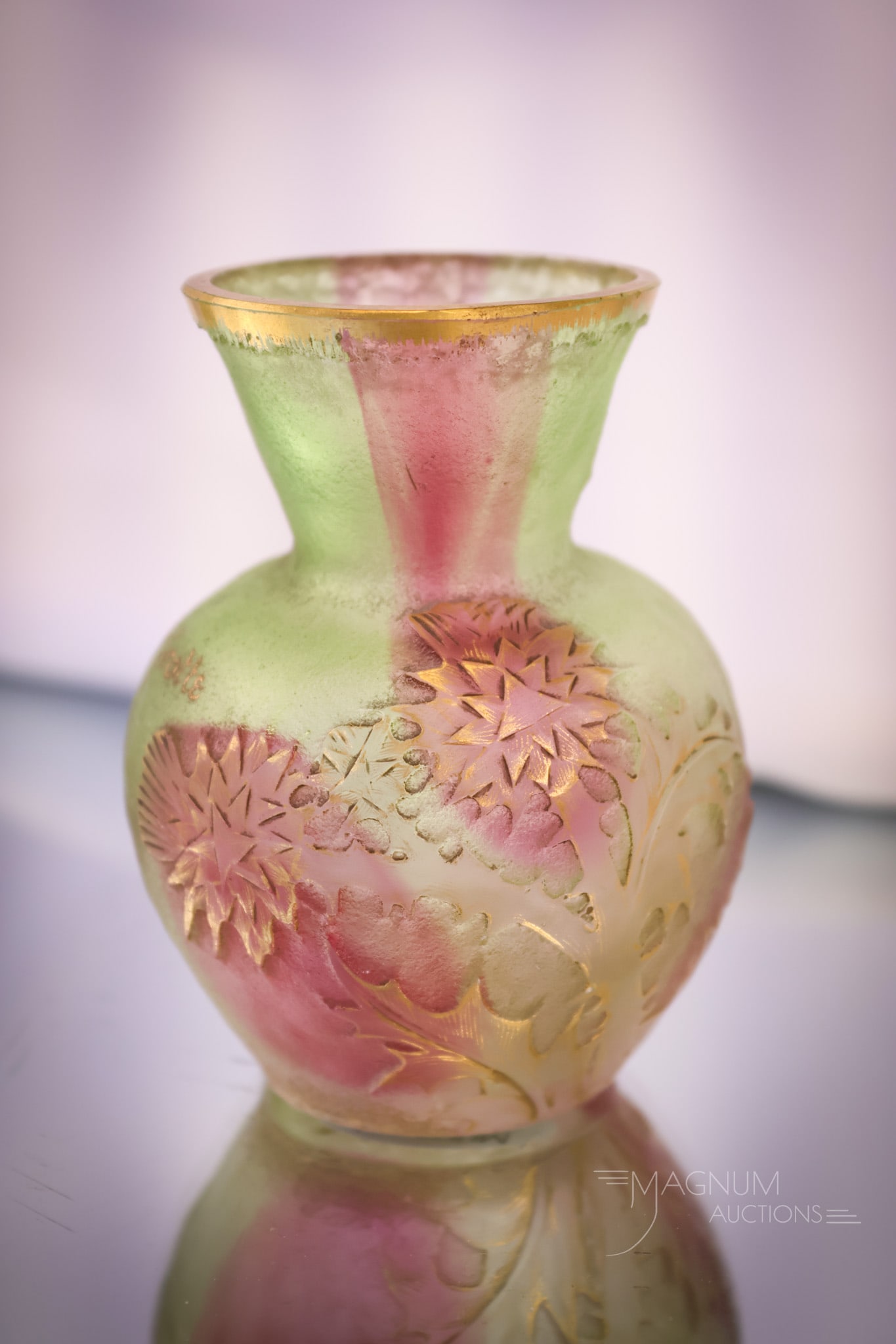 Signed Daum Nancy French Cameo Art Glass Cabinet Vase: A charming find in French cameo art glass. This vase is in green glass with a red swirl through it. The vase is decorated with a cameo-cut thistle flower and a French proverb. It translates to "Whoeve