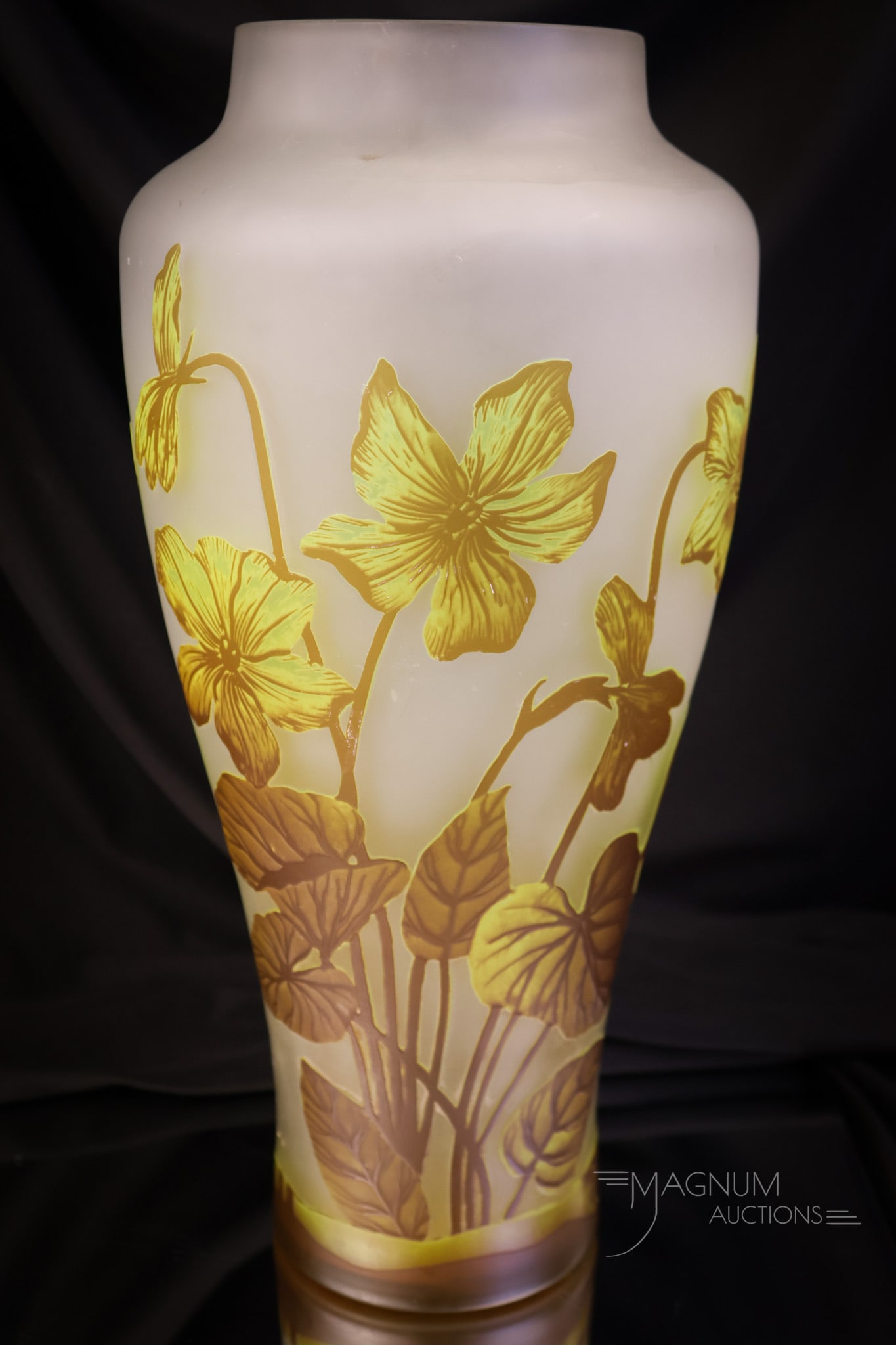 Signed Muller Freres Luneville 13" French Cameo Art Glass Vase: A collection-enhancing find in a signed Muller Freres Luneville French cameo art glass vase. This fine example is decorated with flowers and foliage. It has yellow and brown coloring against a clear b