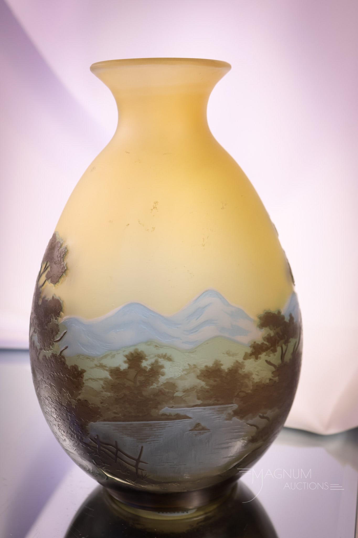 Signed Galle French Cameo Art Glass Mountain Scenic Vase: A great find for your collection! This is a signed Galle French cameo art glass vase. The vase features a scenic mountain and lake decoration with trees. The vase measures 9" tall and 5 1/4" wide. SHI
