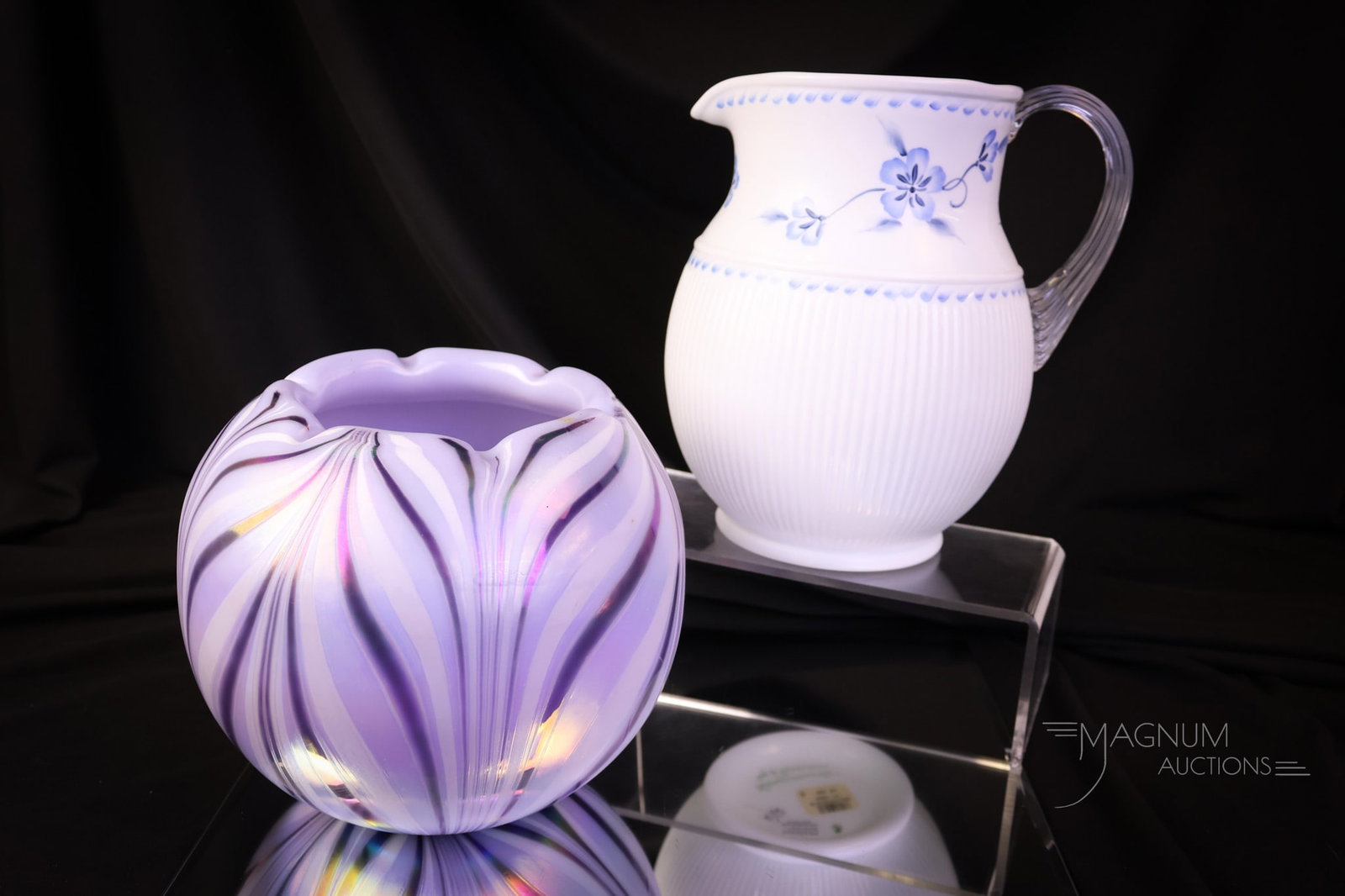 2 pc Lot Fenton Art Glass Dave Fetty & More: Two incredible finds for your collection. This lot offers a "True Blue on Milk Pitcher" and a factory-made Dave Fetty "Lavender Haze" pulled feather rose bowl. The tallest measures 7 1/2". SHIPPING NO