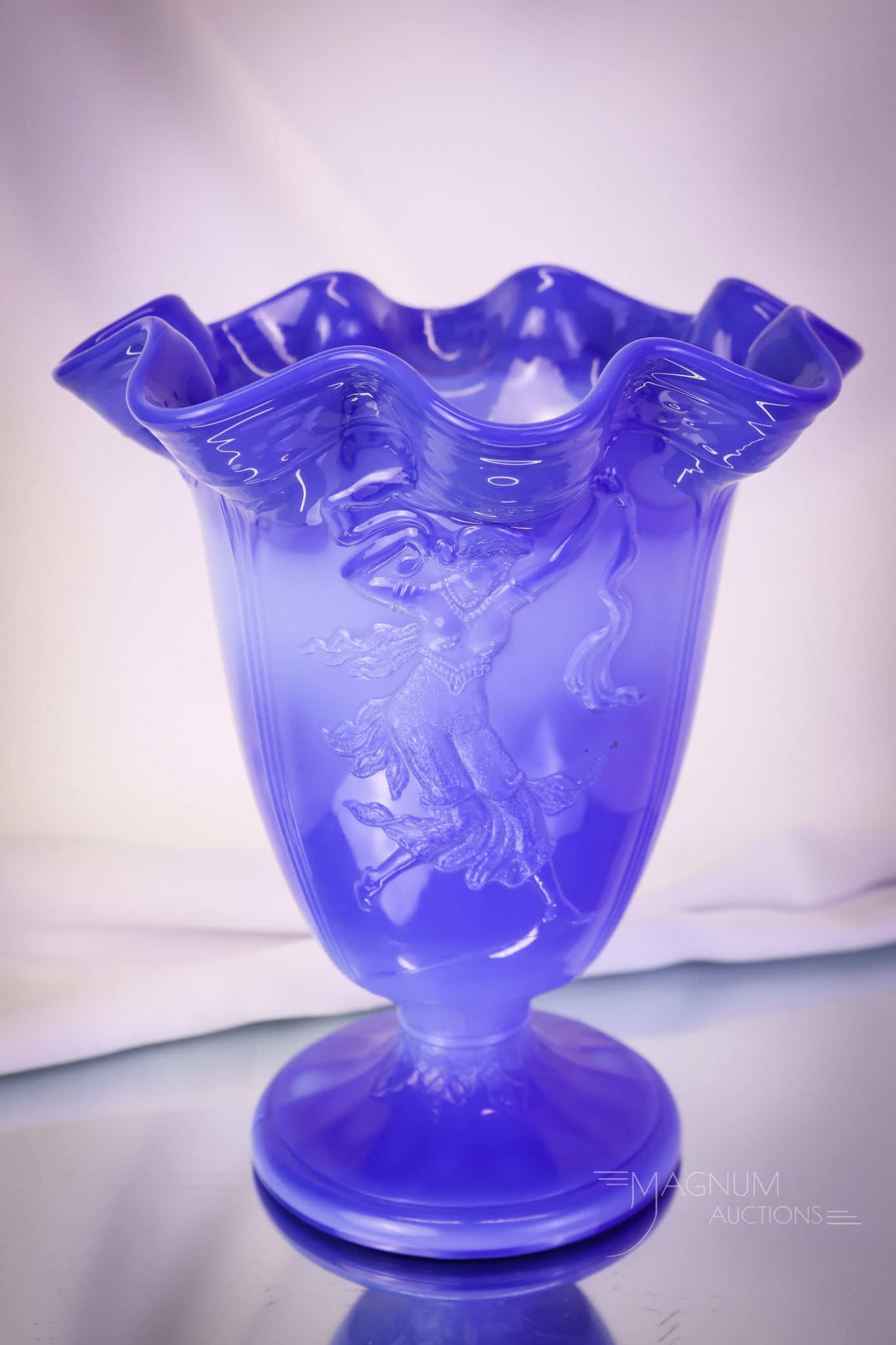 Fenton Periwinkle Blue Dancing Ladies Vase: A fine periwinkle blue Fenton "Dancing Ladies" pattern vase from the 1930's. This one has a ruffled top treatment. The vase measures 8 1/2" tall. SHIPPING NOTICE: If you choose not to utilize the Live