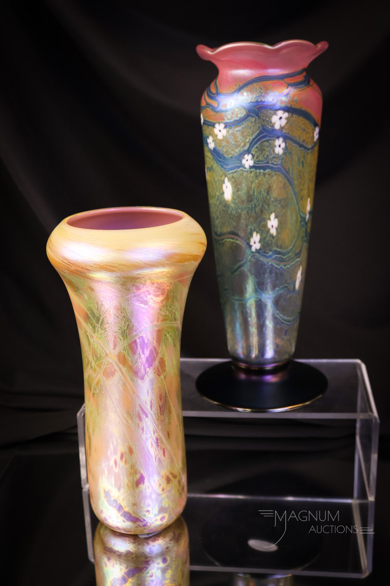 2 pc Lot Contemporary Studio Art Glass Vases: Two nice finds in beautiful contemporary studio art glass. The first is a gold iridescent radical abstract design vase. The second is an iridescent vase with flowers and signed, "Okra Pictv 54." The t