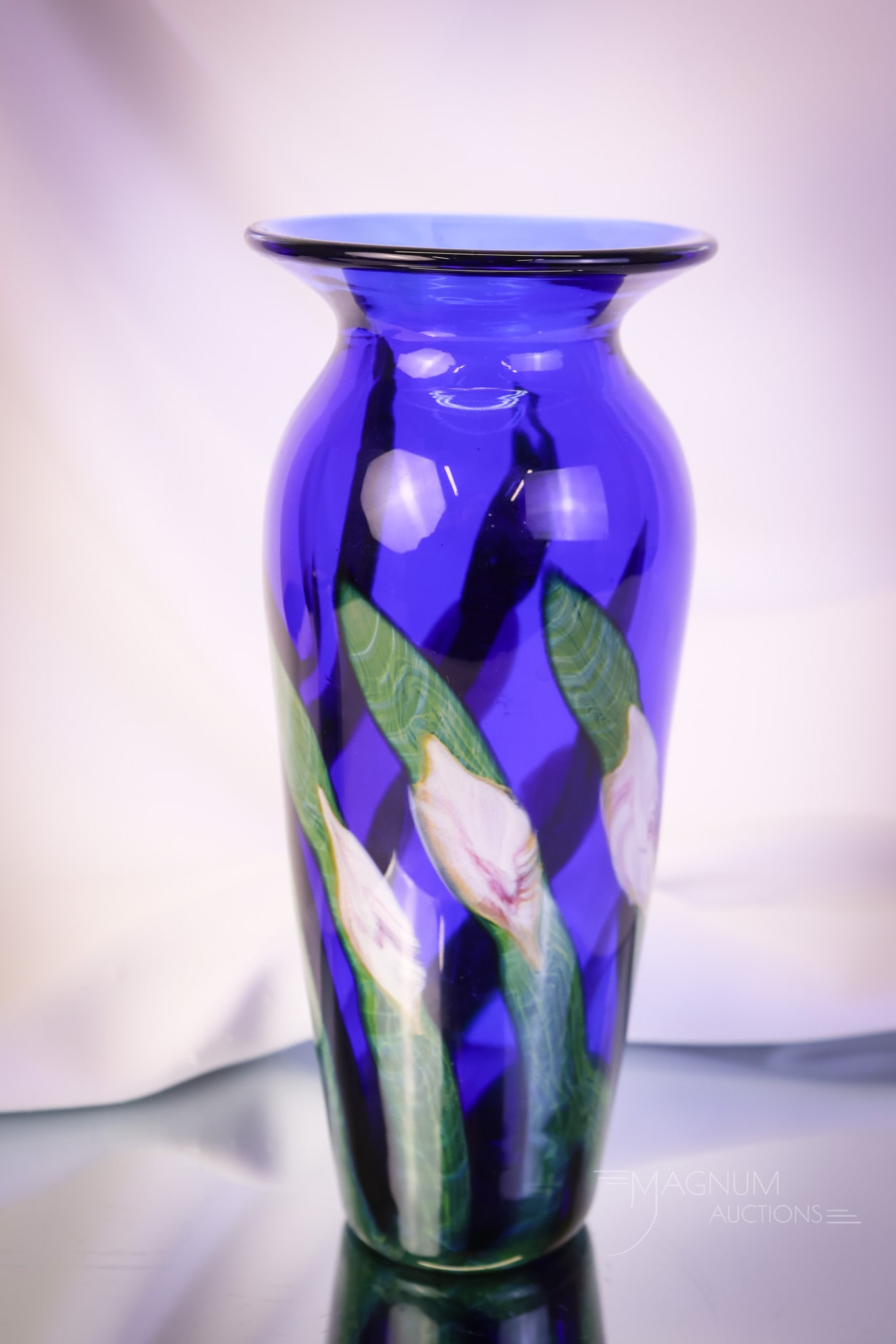 John Lotton 1998 Multi-Flora Art Glass Vase: An eye-catching John Lotton art glass multi-flora vase. This super example is in a cobalt color. It measures 9 1/4" tall. SHIPPING NOTICE: If you choose not to utilize the LiveAuctioneers LiveShip pro