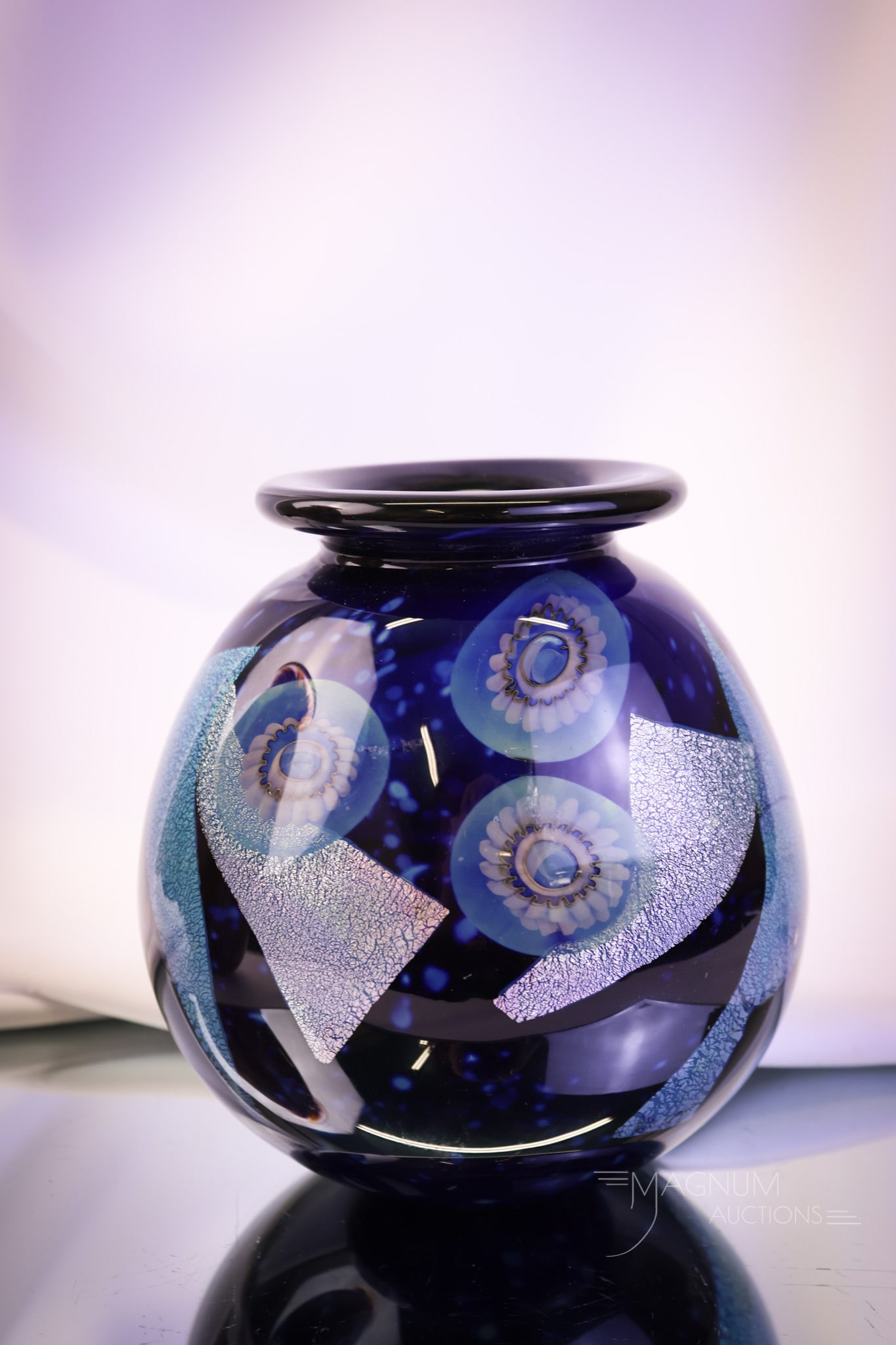 Signed "Eickholt 2002" Dichoric Anemone Midnight Blue Art Glass Vase: A wonderful find in signed Eickholt glass. This piece is signed, "Eickholt 2002." The vase is a midnight blue with dichoric anemone designs. The vase measures 6 1/4" tall and 5 1/4" wide. SHIPPING NOT