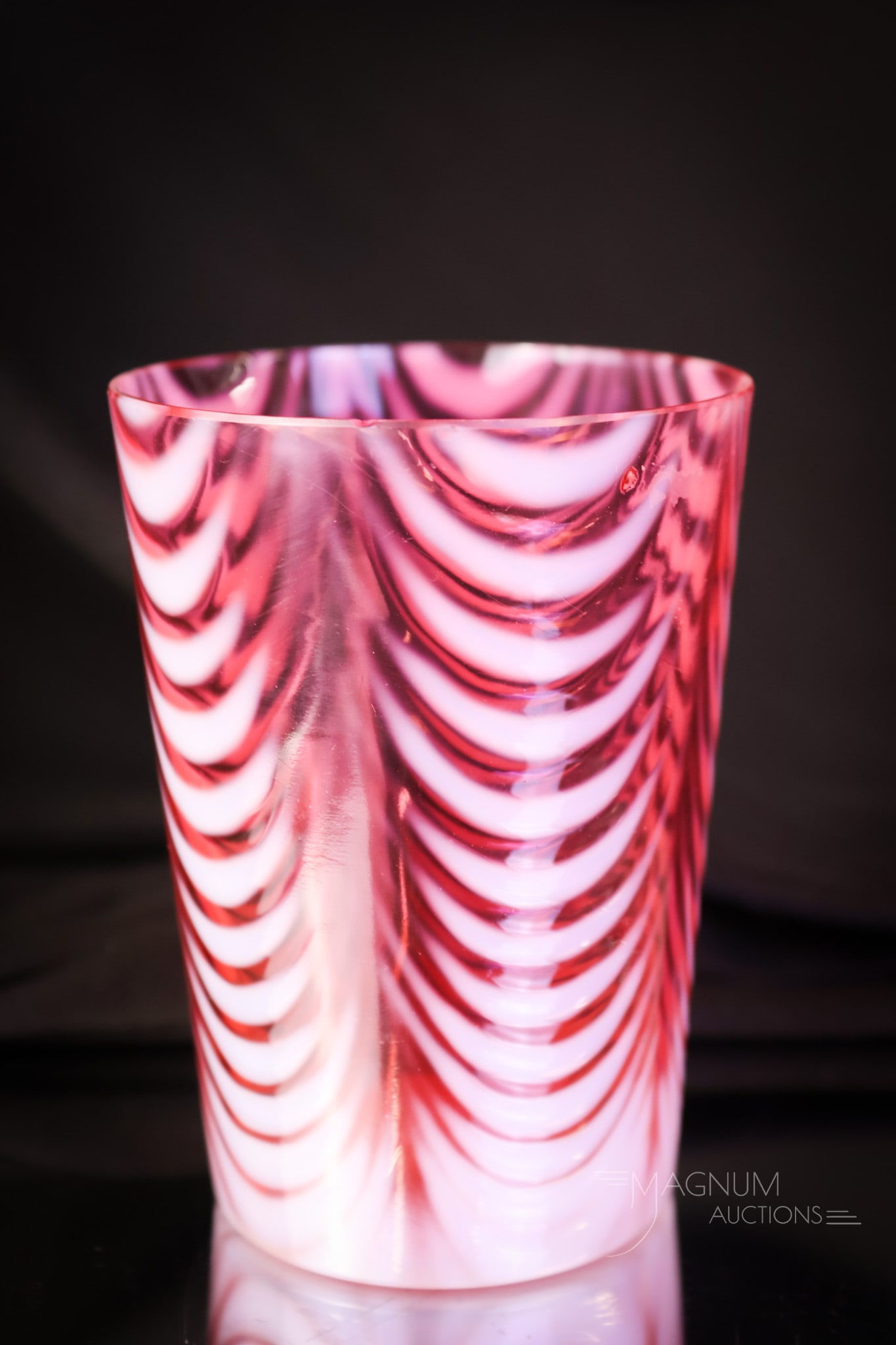Northwood Cranberry Opalescent Drape Victorian Glass Tumbler: A seductive cranberry opalescent Victorian glass tumbler in the Opal Drape pattern. This tumbler has great coloring and bright opal. The tumbler measures 4" tall. Minor fleabites are noted on the rim.