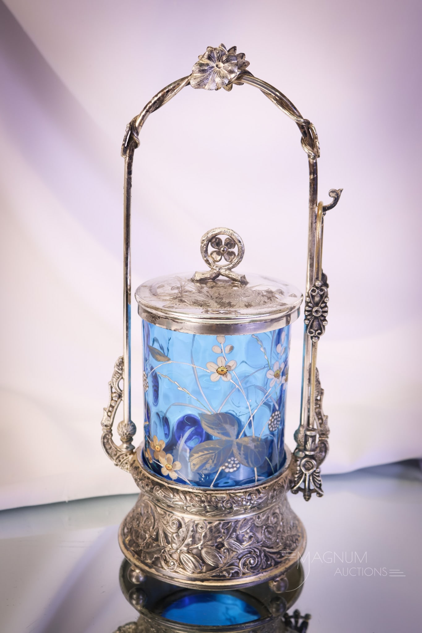 Wilcox Victorian Blue Enameled Art Glass Silverplate Pickle Castor: A beautiful find in a Victorian pickle castor. This castor holds a blue enameled glass jar. The frame is signed Wilcox silverplate. The lid on the jar features birds and butterflies. The castor measur