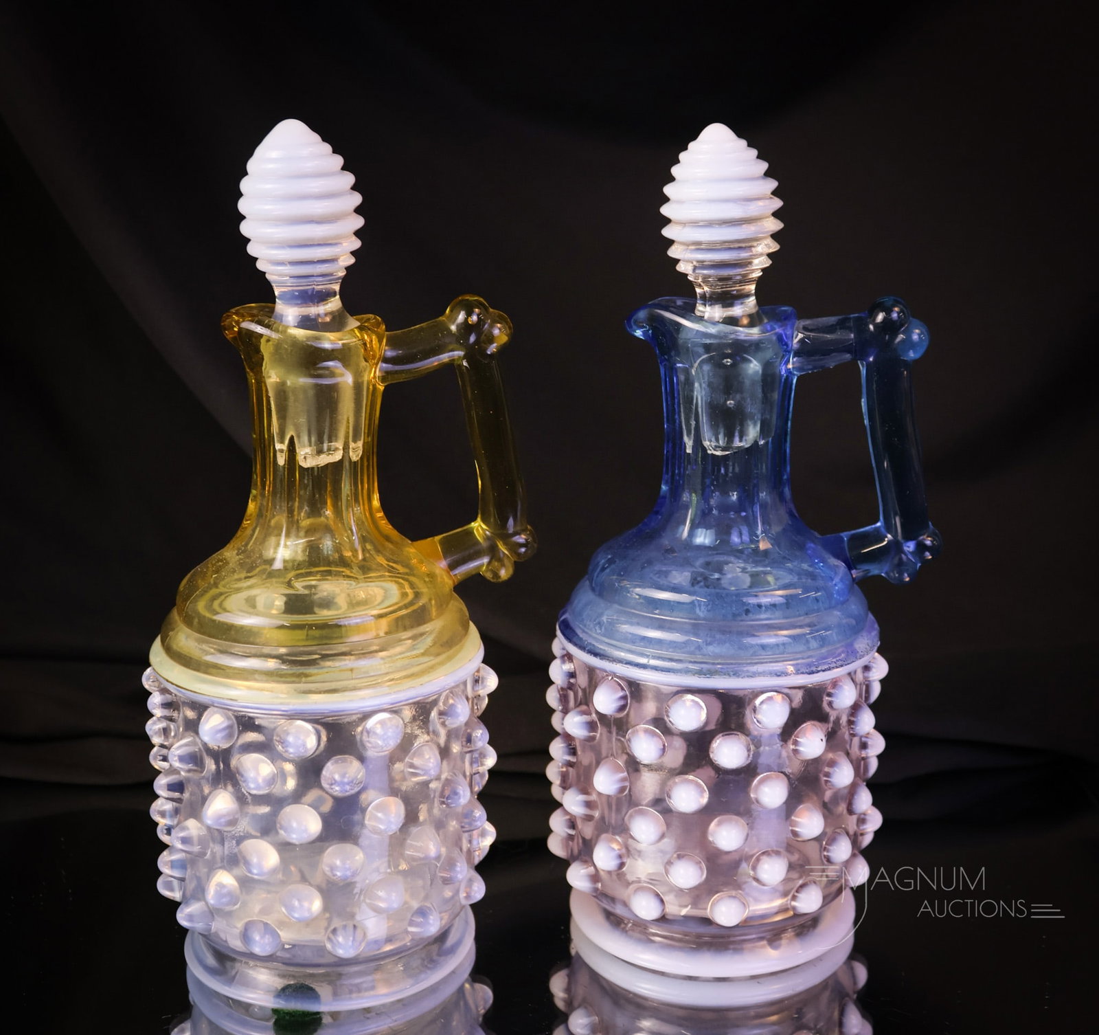 2 pc Lot Gonterman Hobnail Opalescent Victorian Glass Cruets: Two delights that are sure to please in opalescent Victorian glass. This lot offers a blue and an amber opalescent hobnail example in the form of a cruet by Gonterman. Each measures 7" tall, and both 