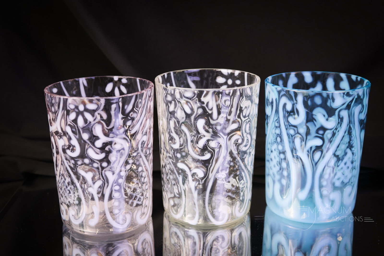 3 pc Lot Northwood Arabian Nights Victorian Opalescent Glass Tumblers: Three tumblers for your growing collection. This lot offers two crystal opal examples and a blue in the Arabian Nights pattern by Northwood. One of the clear examples exhibits a rim flake. The tumbler