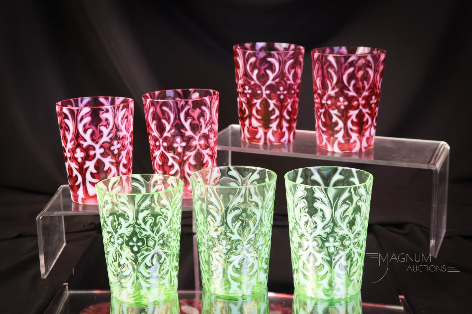 7 pc Lot Victorian Northwood Spanish Lace Glass Tumblers: A generous offering of four cranberry opalescent and three green uranium-rich opalescent tumblers, all in the Spanish Lace pattern. The tallest measures 4". Two of the green exhibit minor rim flakes. 