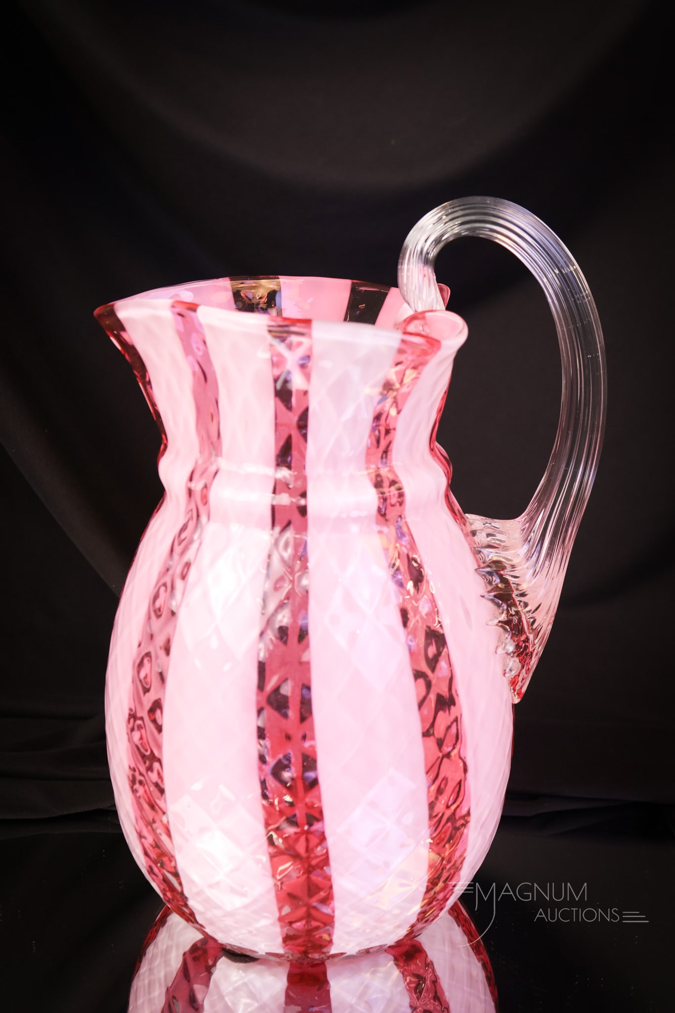 Cranberry Opalescent Diamond Quilt Wide Stripe Heart Water Pitcher: A wonderful addition to any collection. This water pitcher is in the diamond quilt wide stripe pattern in cranberry glass. The pitcher features a heart-shaped top rim. You'll have to bid on this one! 
