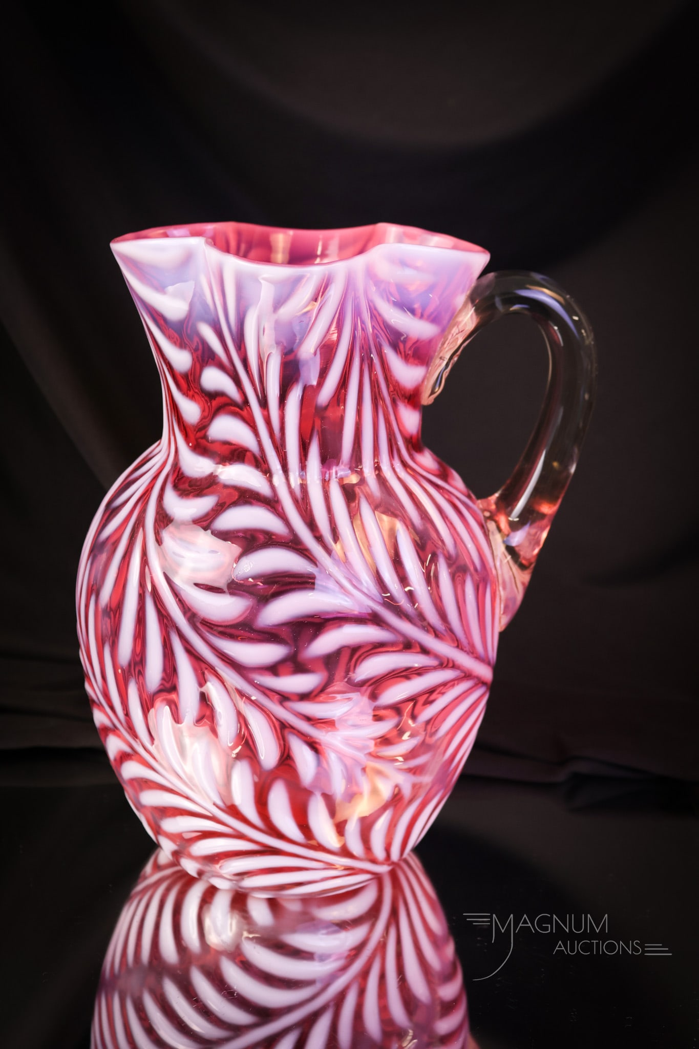 Victorian Cranberry Opalescent Fern Clover Top Water Pitcher: Another beautiful find in our line-up of Victorian opalescent glass. This is a Fern pattern pitcher with a clover-top rim. Such nice color and opalescence. The pitcher measures 8 1/2" tall. SHIPPING N