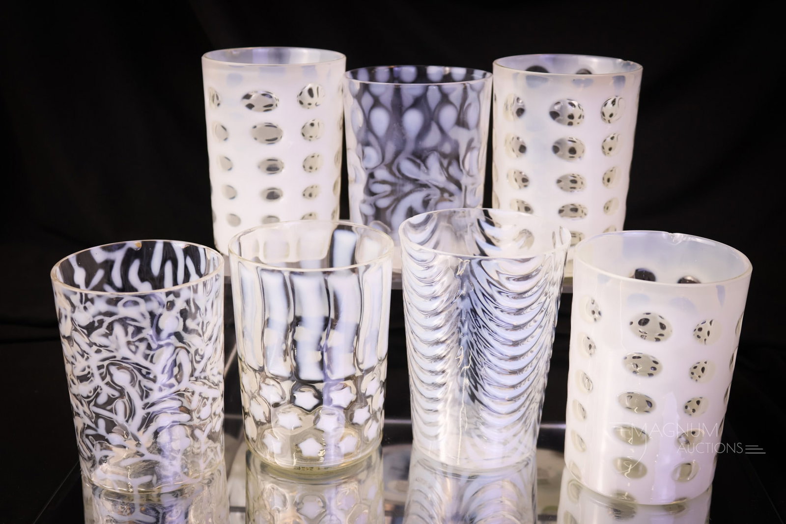 7 pc Lot Victorian Opalescent Glass Tumblers: A select offering of seven Victorian crystal opalescent tumblers from the Victorian age. Patterns include Polka-dot, Buttons & Braids, Opal Drape, Seaweed, and Stars & Stripes. The tallest measures 4"