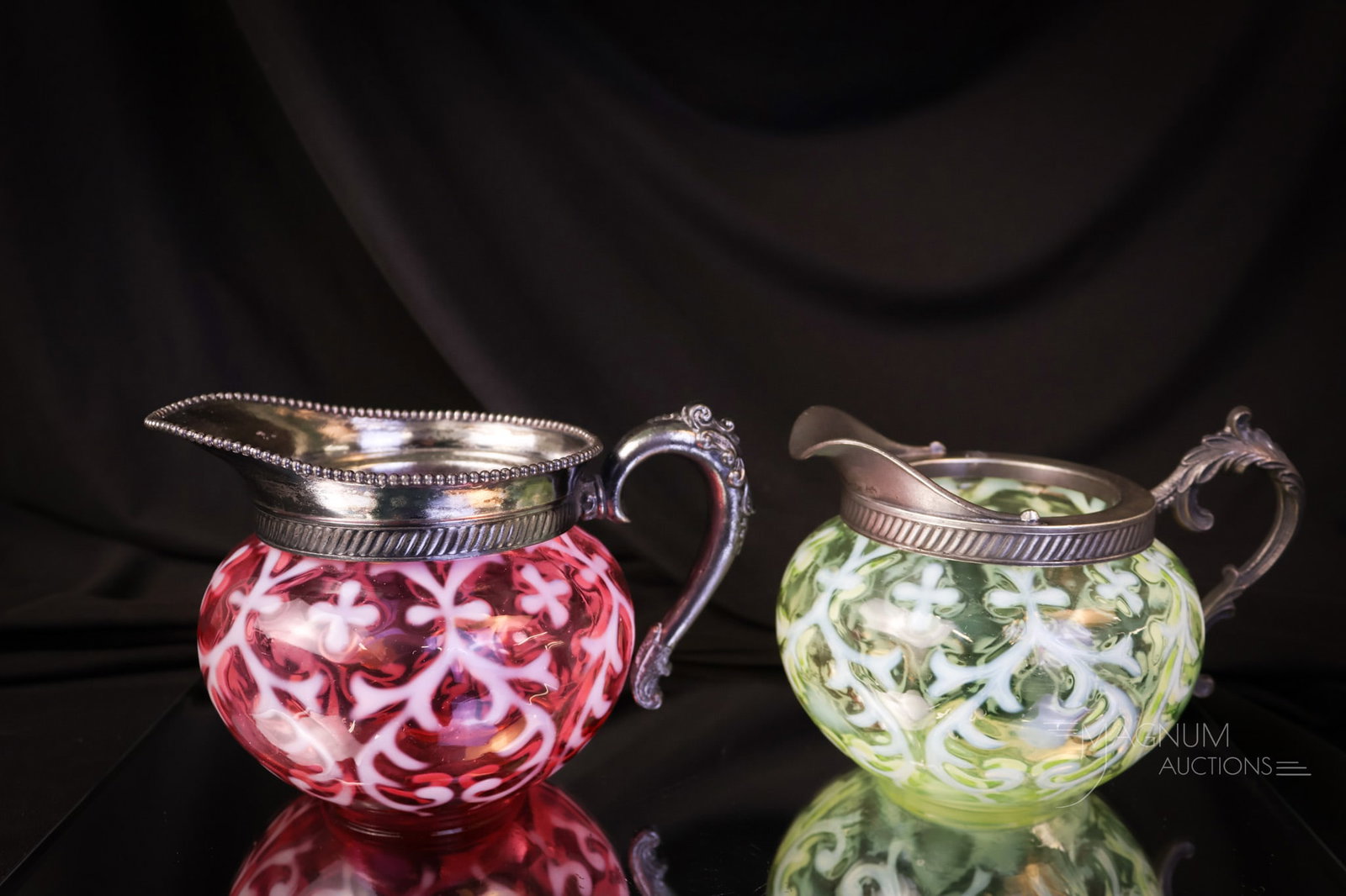2 pc Lot Northwood Cranberry Uranium Vaseline Spanish Lace Creamers: Two distinct examples of Northwood Spanish Lace pattern creamers. One in rich cranberry opal and one in glowing uranium-rich vaseline opal. The tallest measures 3 3/4". SHIPPING NOTICE: If you choose 
