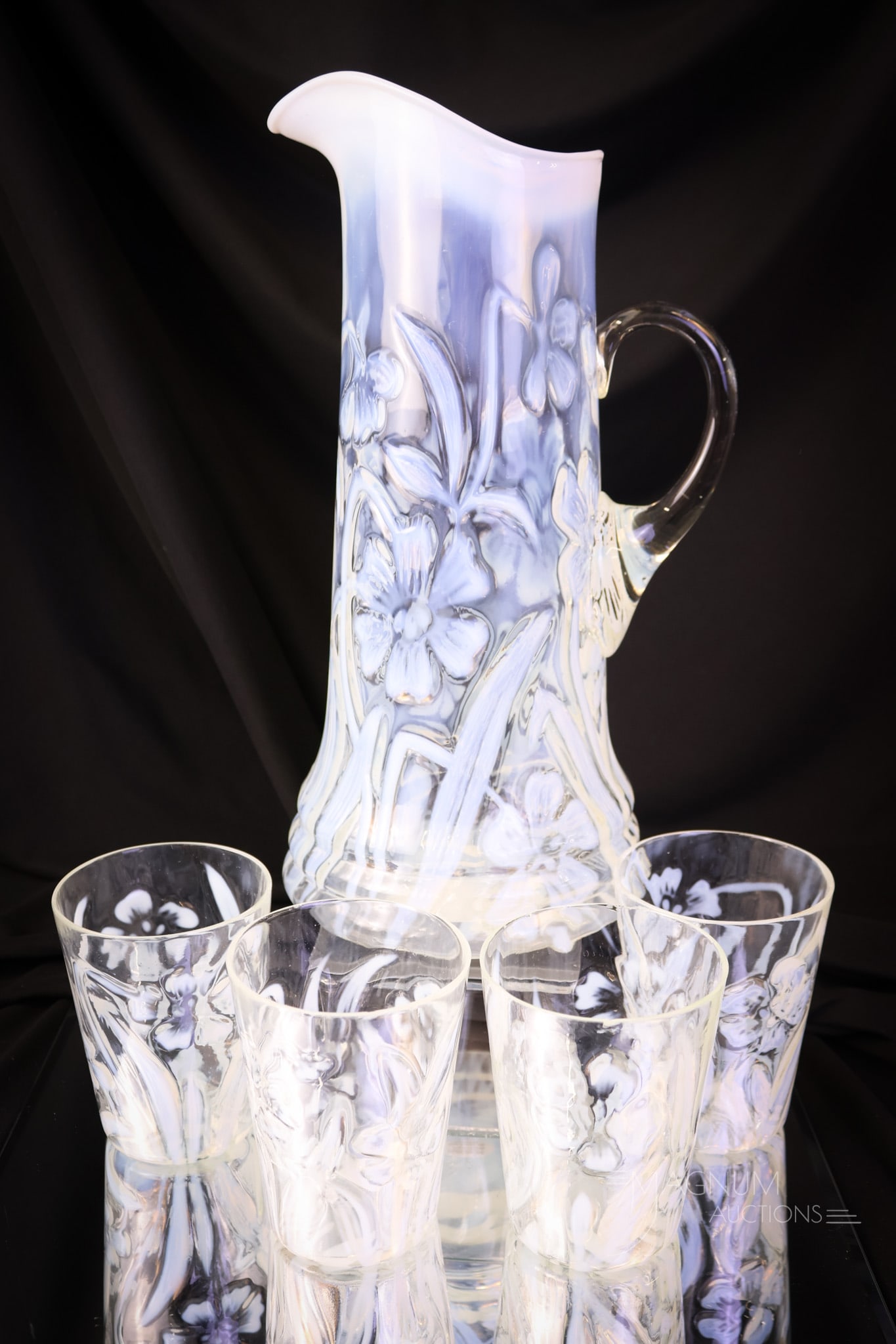 5 pc Northwood Daffodils Victorian Opalescent Glass Water Set: A seldom-seen offering. This is a five-piece water set in the Northwood pattern, Daffodils in crystal opalescent. This set features the tankard water pitcher along with four tumblers. The tallest meas