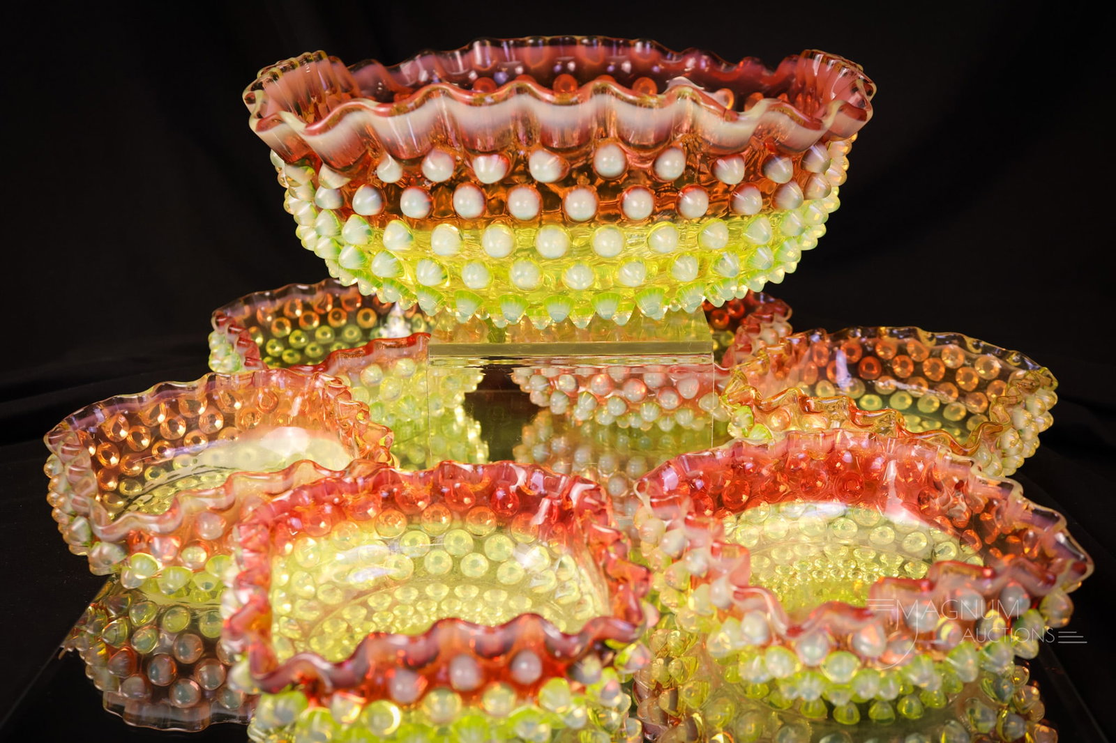 Hobbs Cranberry Uranium Vaseline Opalescent Hobnail 7 pc Berry Set: A gorgeous offering of a seven-piece berry set by Hobbs. This set is in cranberry to vaseline uranium-rich glass with opalescence. The set consists of a master berry bowl and six individual berry bowl