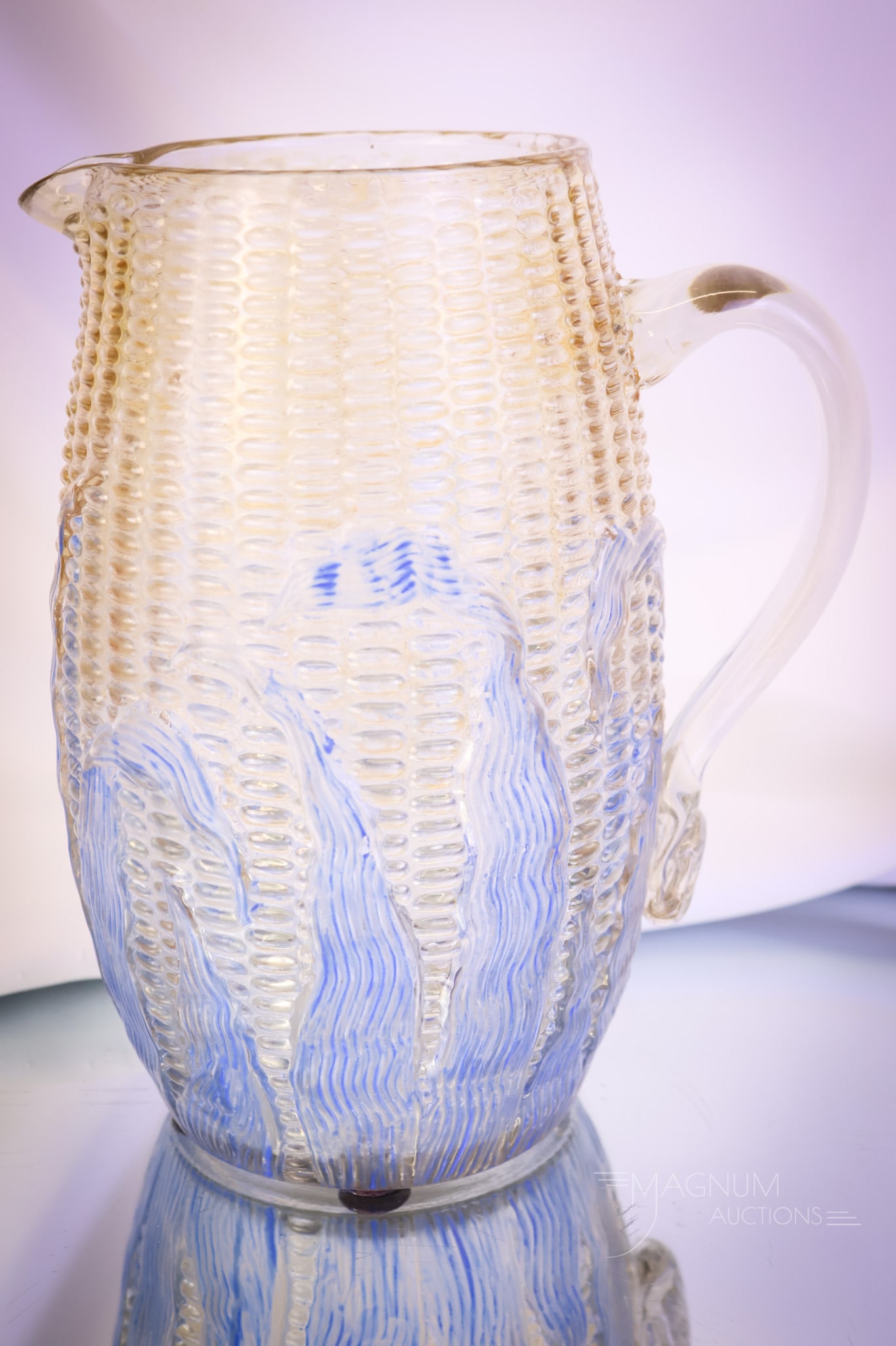 Libbey Maize Victorian Glass Stained Water Pitcher: A super find and a rare example. This pitcher is in the Libbey Maize pattern. The pitcher is clear with a brown stain and blue husk decoration. Seldom do you see this pattern and this piece in particu