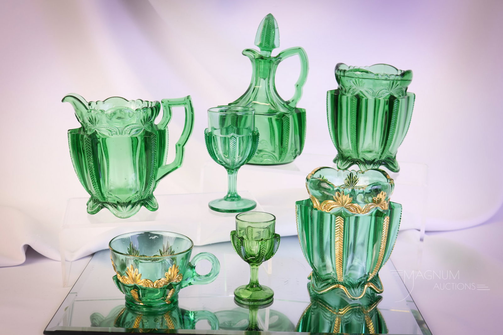 7 pc Lot Greentown Victorian Glass Herringbone Buttress Pattern: A generous offering of Victorian Greentown Green Herringbone Buttress pattern. The lot offers a spooner and a punch cup with gold decoration. A wine, a cordial, and a spooner without gold. There is al