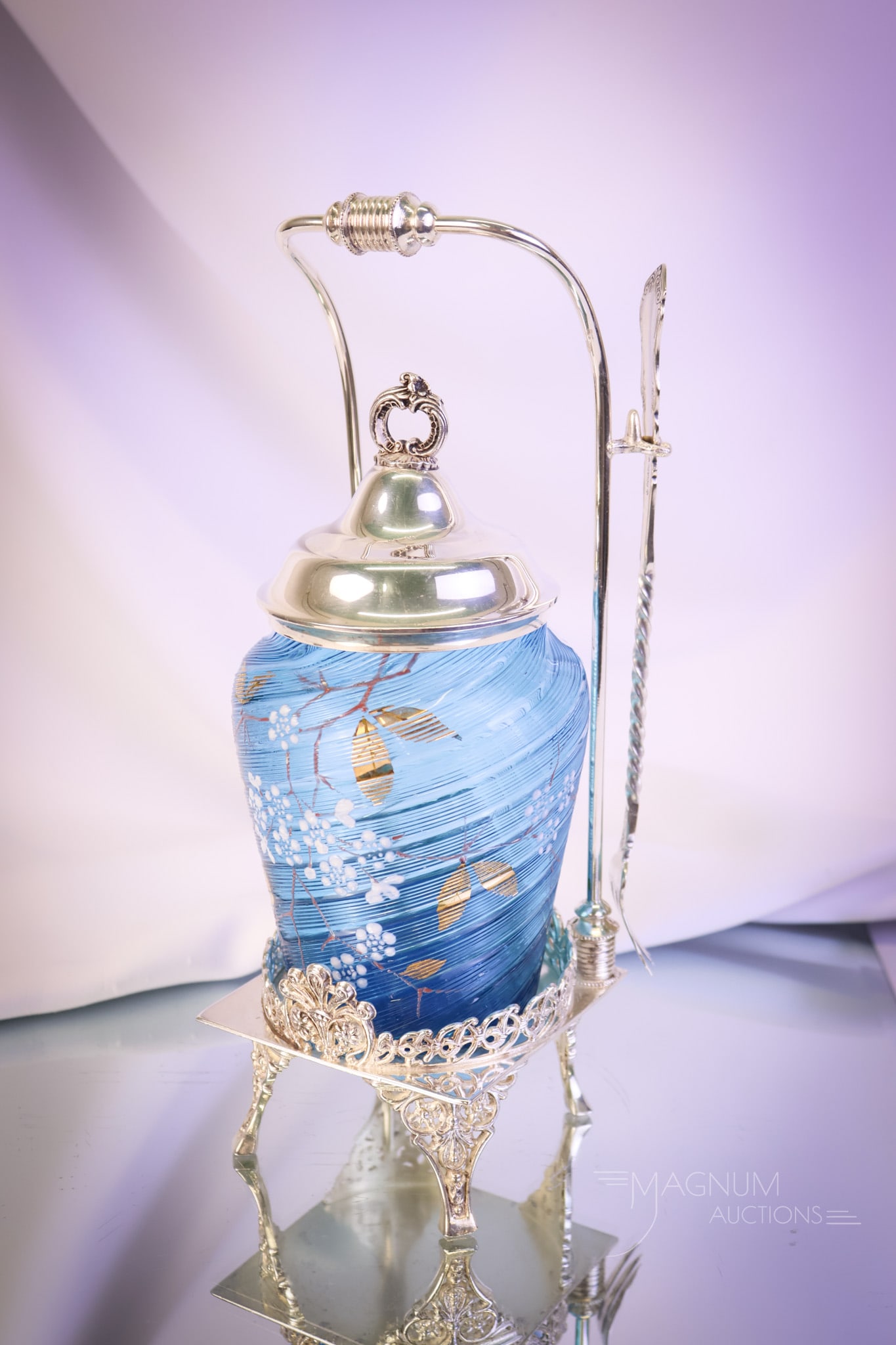 Racine Victorian Silverplate Blue Gilt Pickle Castor: A delightful addition to your collection! This piece is a signed Racine silverplate pickle castor. The frame holds a blue-gilt, threaded pickle jar. The complete castor measures 10 1/2" tall. SHIPPING