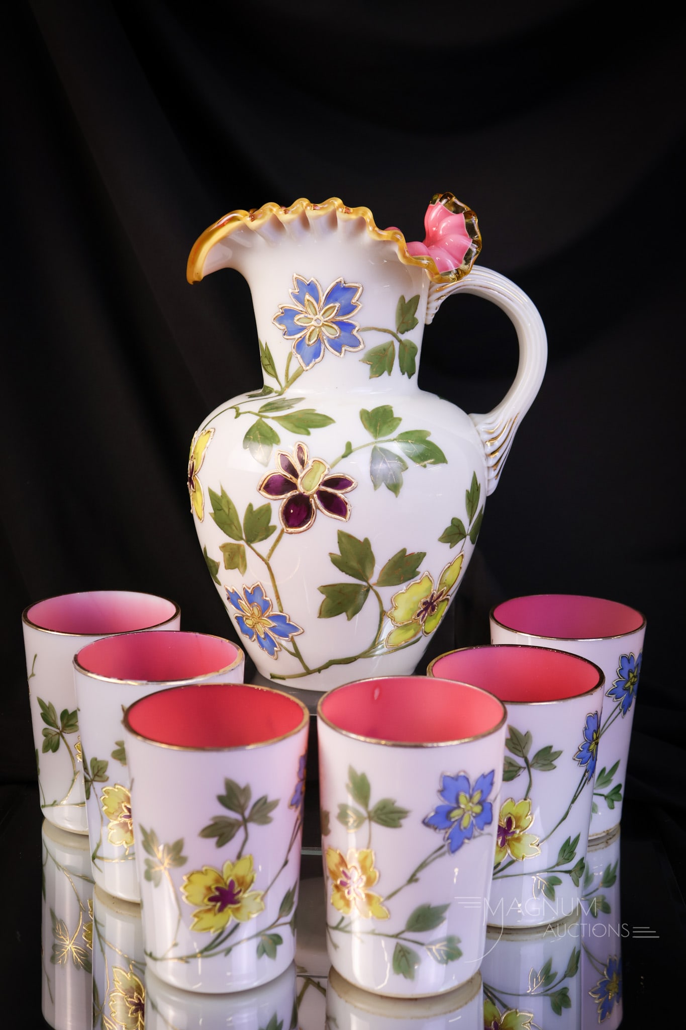 7 pc Victorian Peachblow Uranium Glass Gilt & Enameled Water Set: A beautiful and complete Victorian uranium-rich peachblow glass water set. This set is finely decorated with florals and gilt work. The pitcher has an amber rim. The set glows brightly under black lig