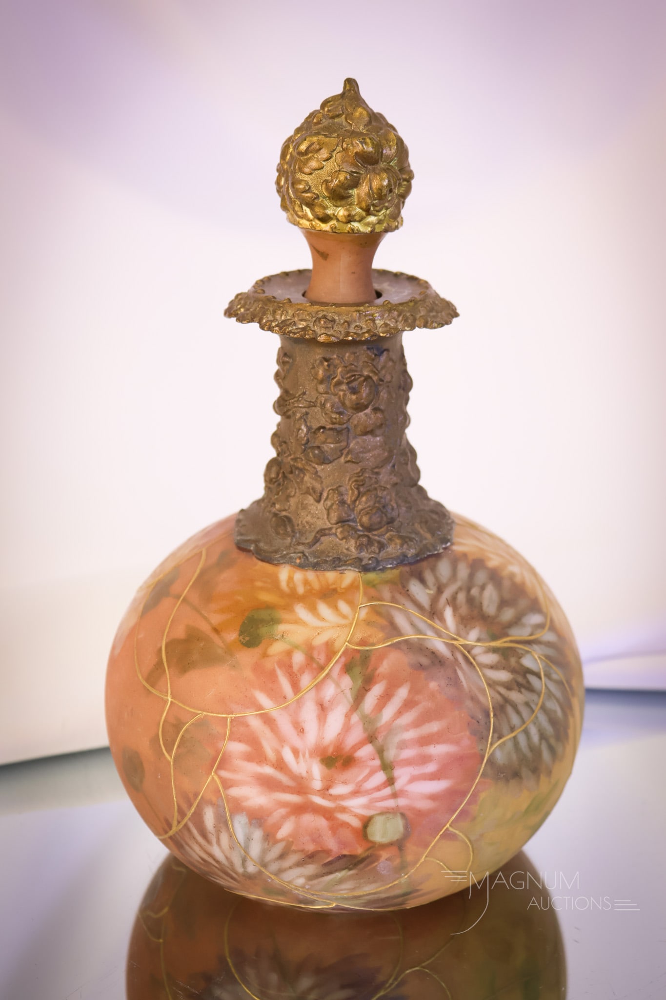 Antique Pairpoint Art Glass Cologne Bottle: A wonderful find in antique Pairpoint glass. This is a cologne bottle complete with the original stopper. This bottle is decorated in earth tones and colorful chrysanthemums. The bottle measures 8"