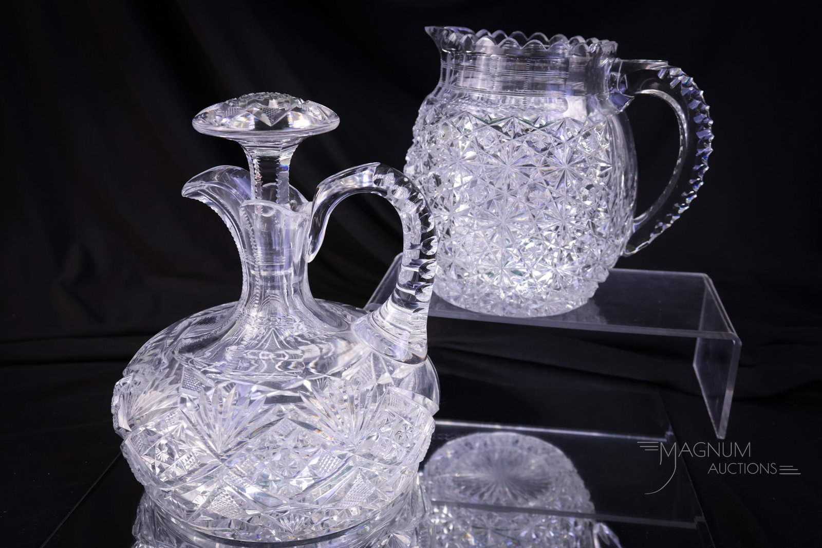 2 pc Lot American Brilliant Period Cut Glass Jug & Whiskey Decanter: Two striking finds in American Brilliant Period cut glass. The first is a Russian cut jug. The second is a Whiskey decanter with Strawberry & Fan cutting and a matching stopper. The tallest measures 7