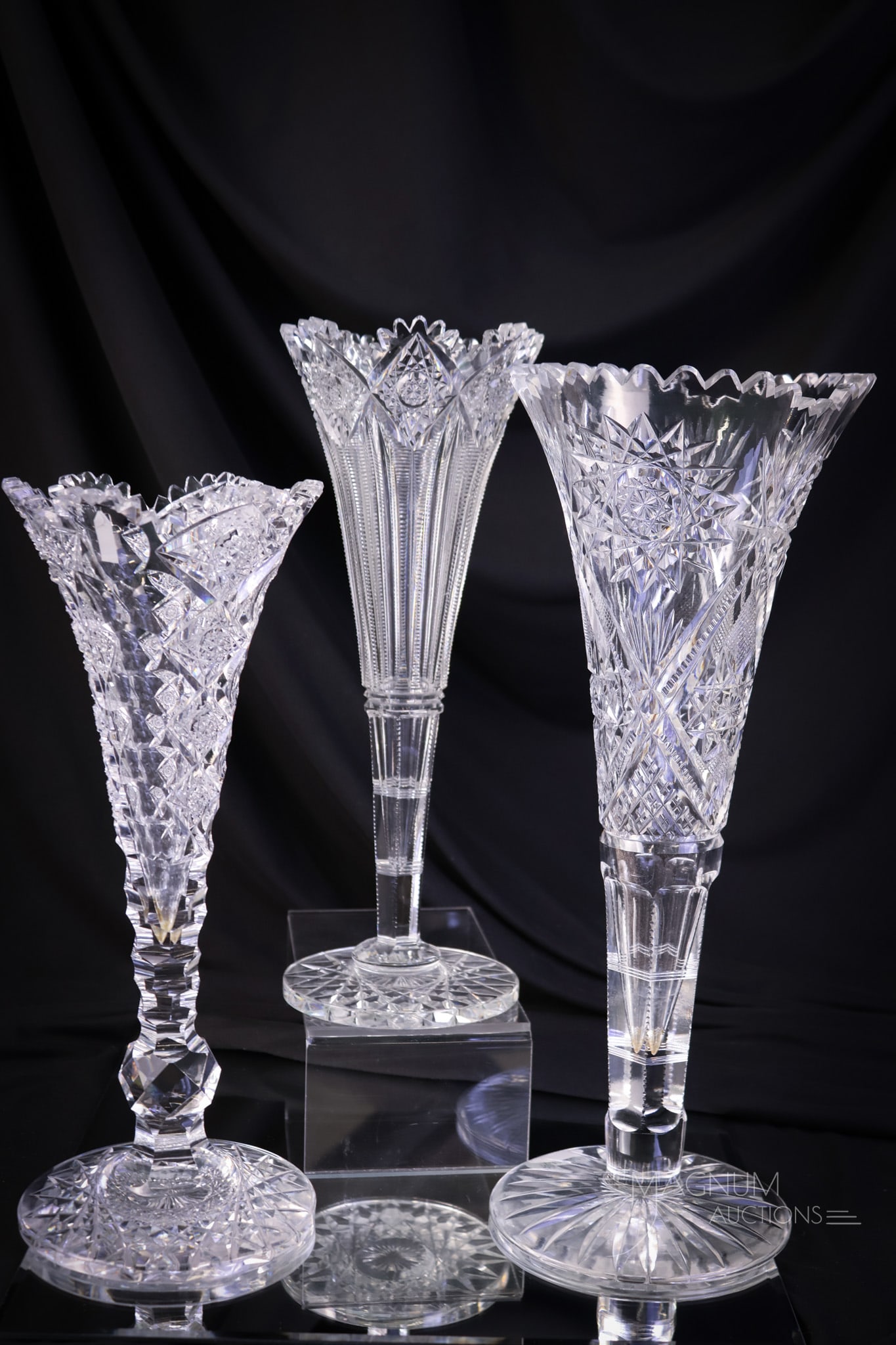 3 pc Lot Hawkes & More ABP American Brilliant Period cut glass trumpet vases: Three desirable finds in American Brilliant Period cut glass trumpet vases. Two examples are signed Hawkes. One in the Queens pattern and one in the Brunswick pattern. The third is unsigned. The talle