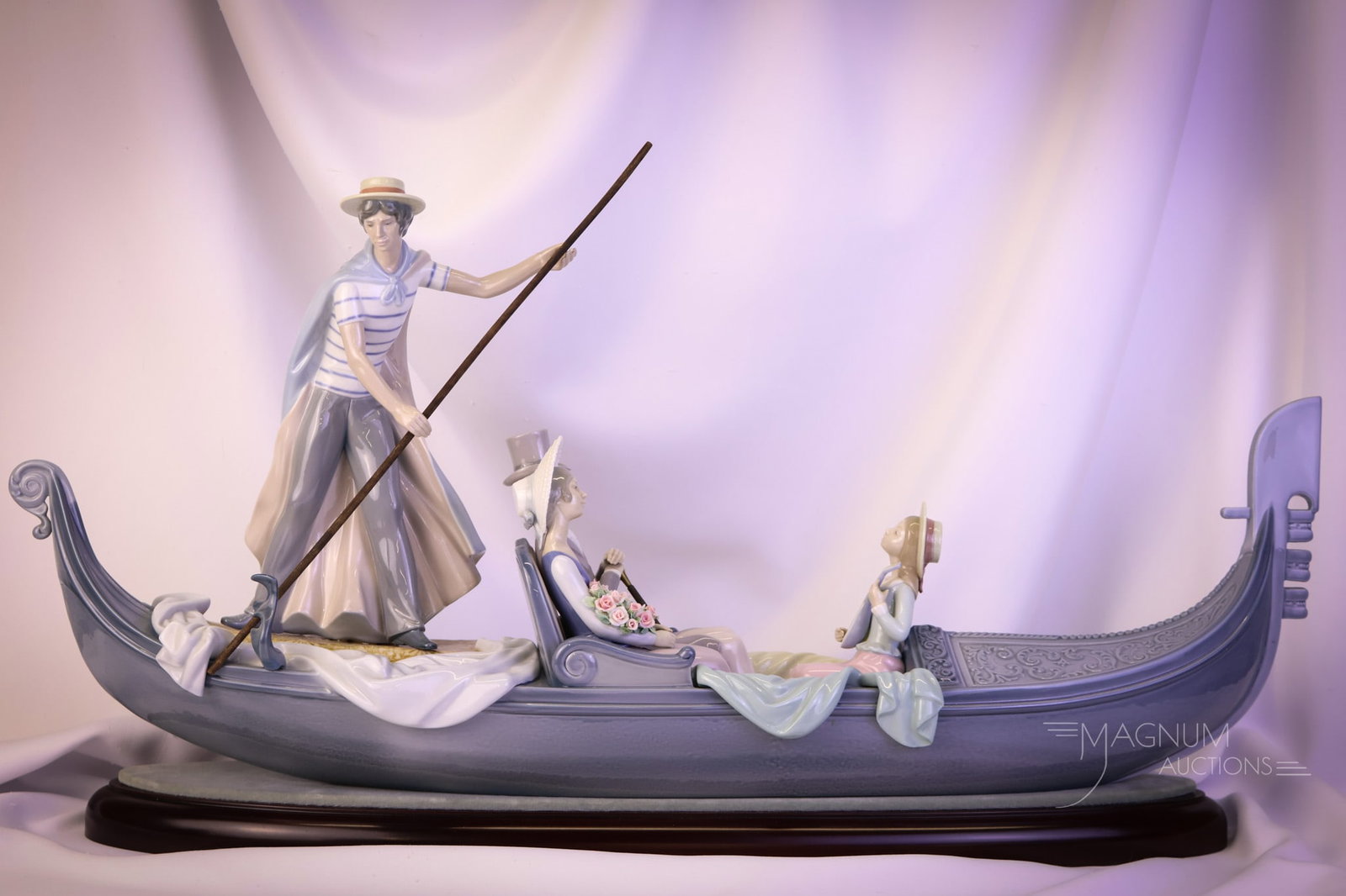 Lladro 30" Italian Gondola Porcelain Figurine: A wonderful find in our auction. This is a Lladro porcelain figurine of a gondola with figures. This piece is signed on the base and also comes complete with a velvet-topped base. This wonderful piece