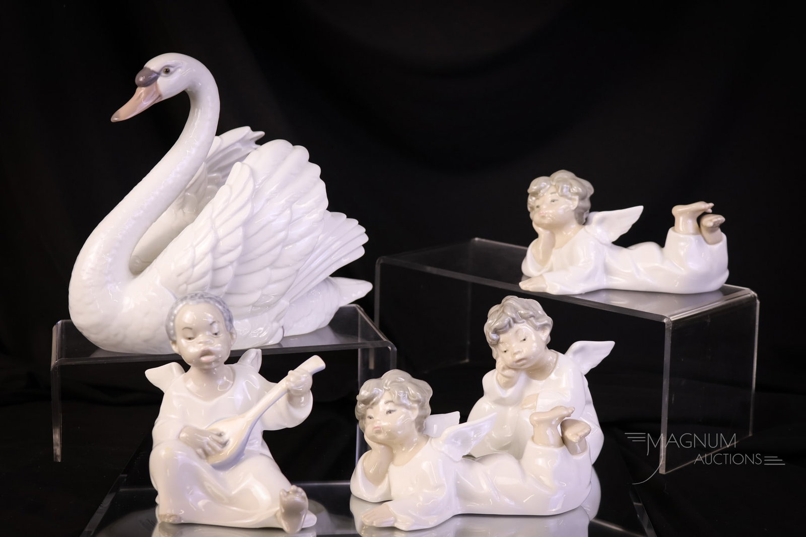 5 pc Lot Lladro Porcelain Figurines: A select assortment of five Lladro figurines including a swan. The tallest measures 7". SHIPPING NOTICE: If you choose not to utilize the LiveAuctioneers LiveShip program, MAGNUM AUCTIONS always offer
