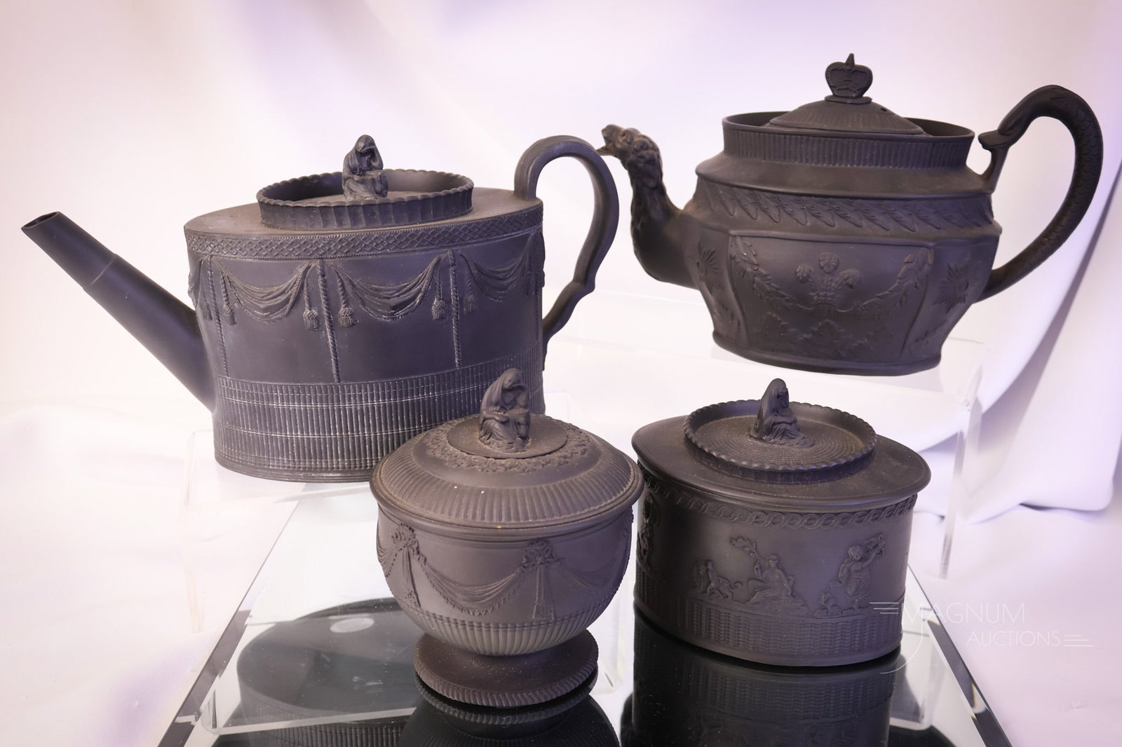 4 pc Neale & Co. Black Basalt Wedgwood Style Tea Set Articles: A beautiful four-piece lot Neale & Co. black basalt tea set articles. The first is a teapot with a dragon finial and spout. The remaining three pieces are a matched set with figural finials, including
