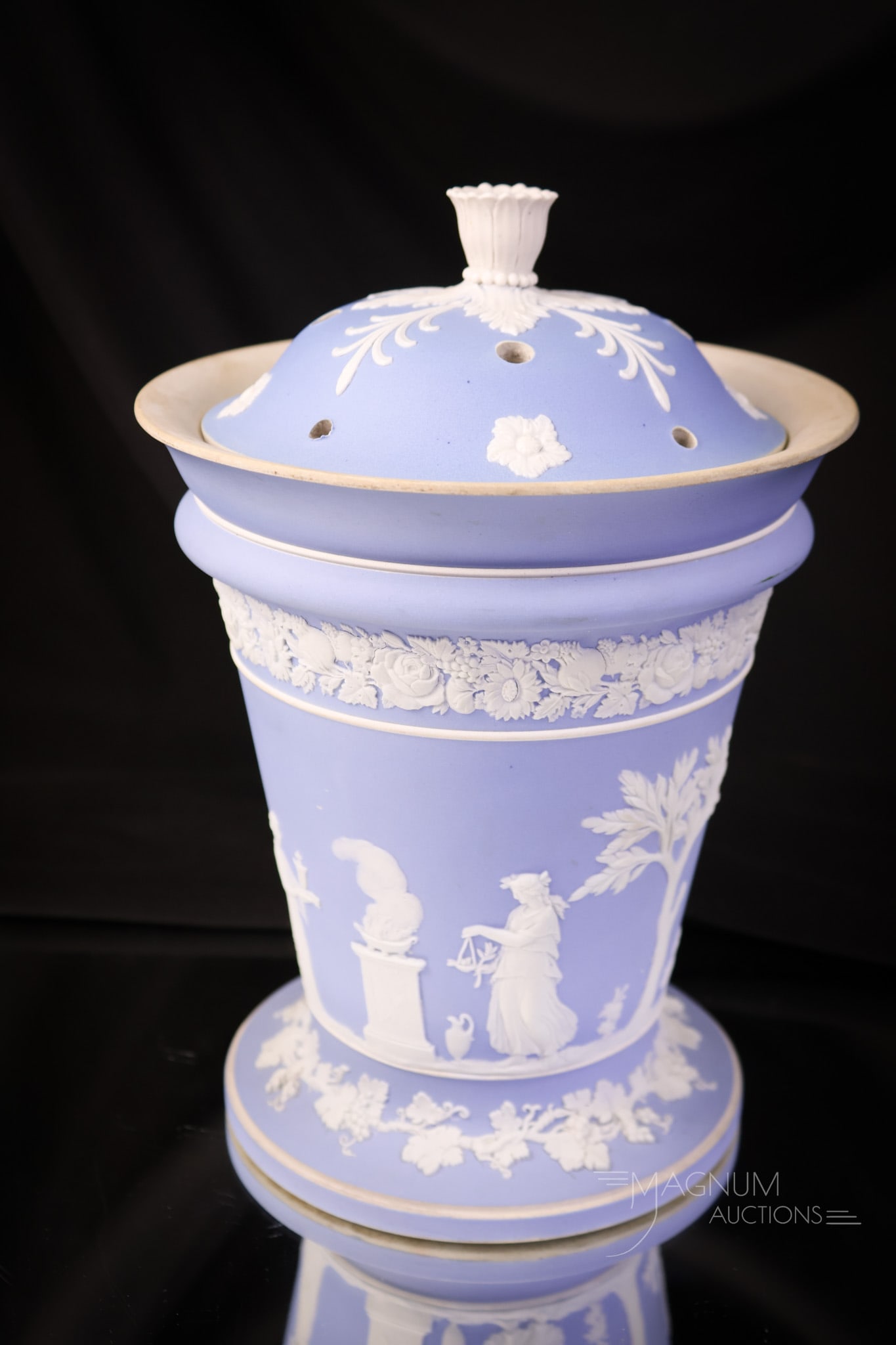 Marked Wedgwood Blue Jasperware Lidded Vase or Potpourri: A beautiful find in a piece of marked Wedgwood Jasperware. This is a lidded vase or potpourri jar. The lid has a three-dimensional flower finial. The piece also has a tin liner. The jar measures 9 1/2