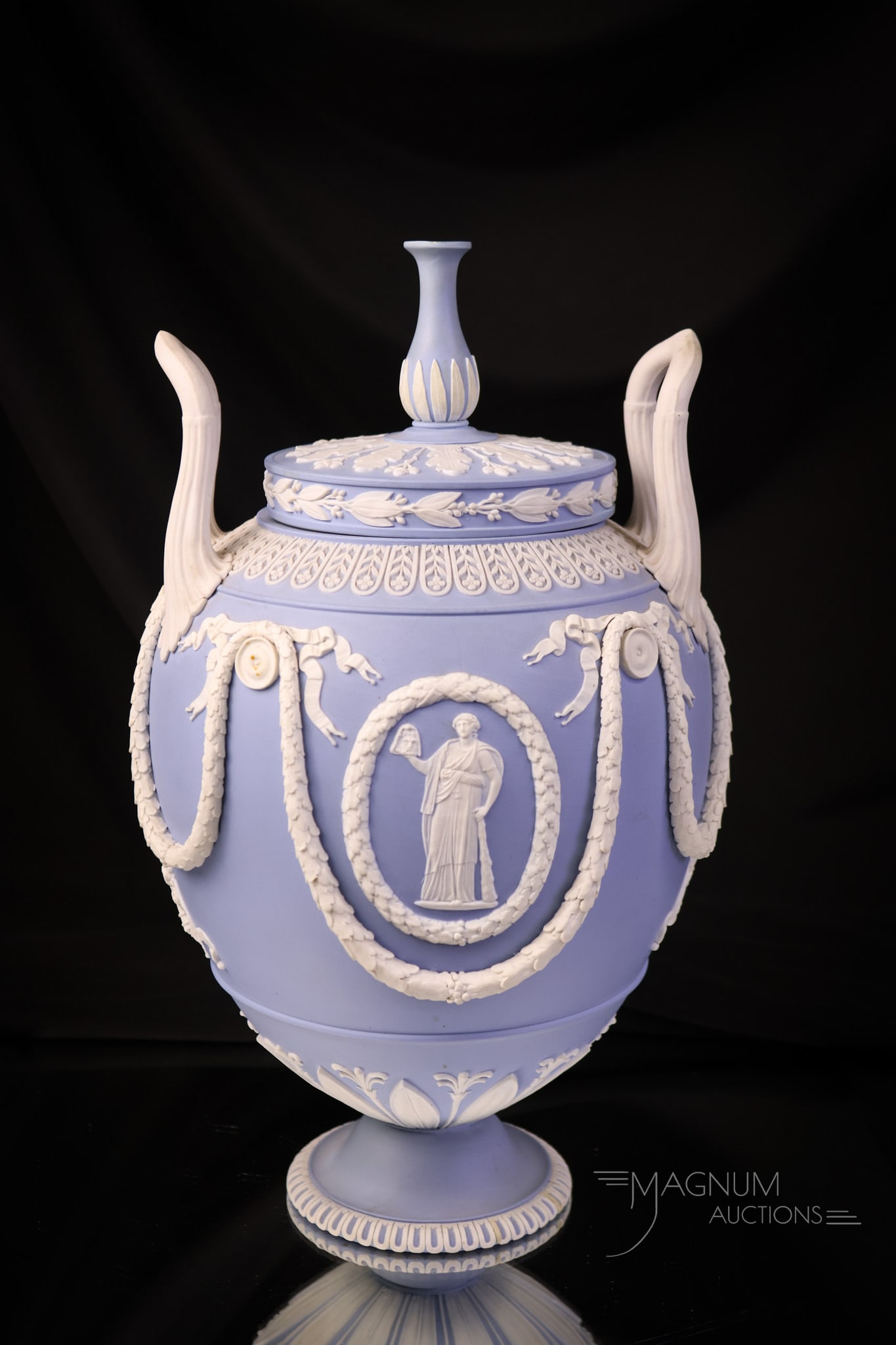 Marked Wedgwood Blue Jasperware Bolted Covered 12" Urn: This super find in marked pale blue Wedgwood Jasperware would be a highlight of any collection. This piece is quite elaborate and intricately detailed. The urn measures 12" tall and 6 1/2" wide. The u