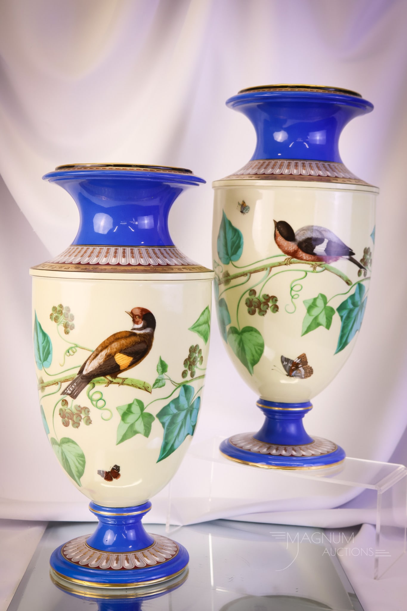 2 pc Lot Old Paris 16" Mantle Vases: A fine pair of 16" tall Old Paris mantle vases. This is an opposing pair of vases. Each is decorated with birds on branches, along with butterflies and bees. Each vase has blue and gold on the top and