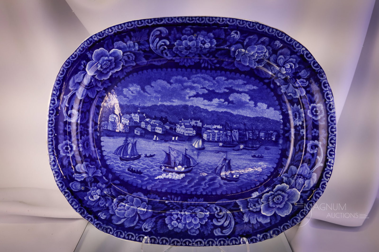 Rare Clews Staffordshire Flow Blue "Sandusky Bay" Platter: A rare find in a Clews Staffordshire Flow Blue "Sandusky Bay" platter. This piece measures 16 1/2" wide. There are three stilt marks on the blue side. The platter exhibits light scratches and crazing.