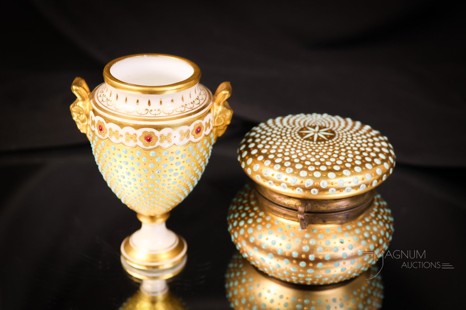 2 pc Lot Coalport Porcelain: Two desirable finds in Coalport porcelain. The first is a miniature urn vase with fine blue dot decoration and gold. It also features ram's head handles. The second piece is a round hinged box with al