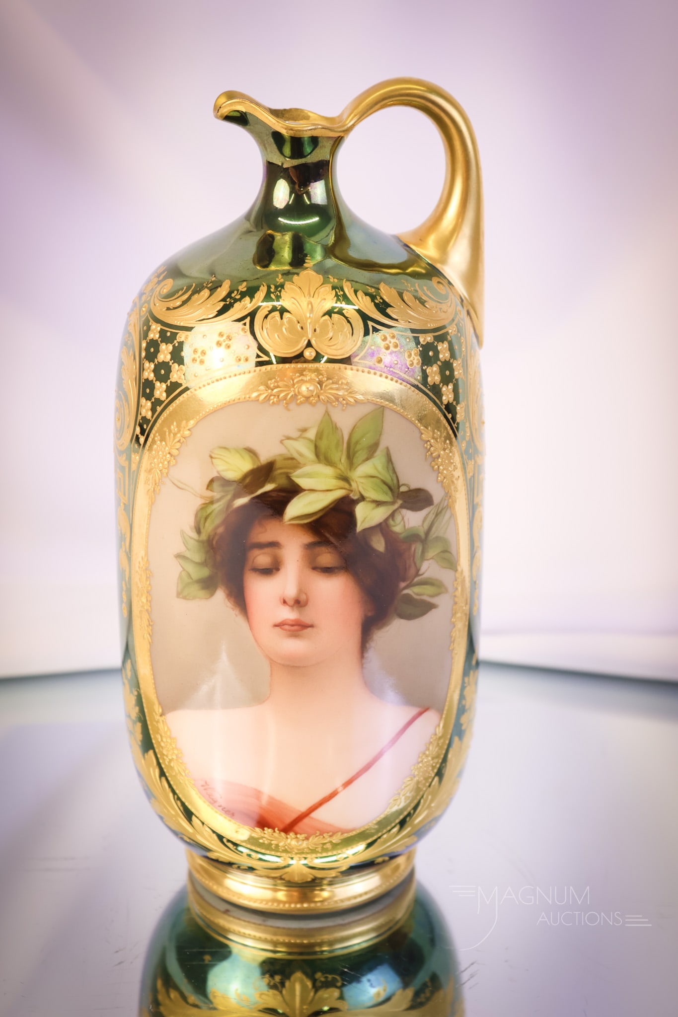 Royal Vienna Porcelain Daphne Portrait Ewer: A classic for your collection. This is a Royal Vienna portrait ewer of Daphne. It is decorated with green/blue iridescent and fine gold work detail. The piece is artist-signed, "Wagner." The ewer meas