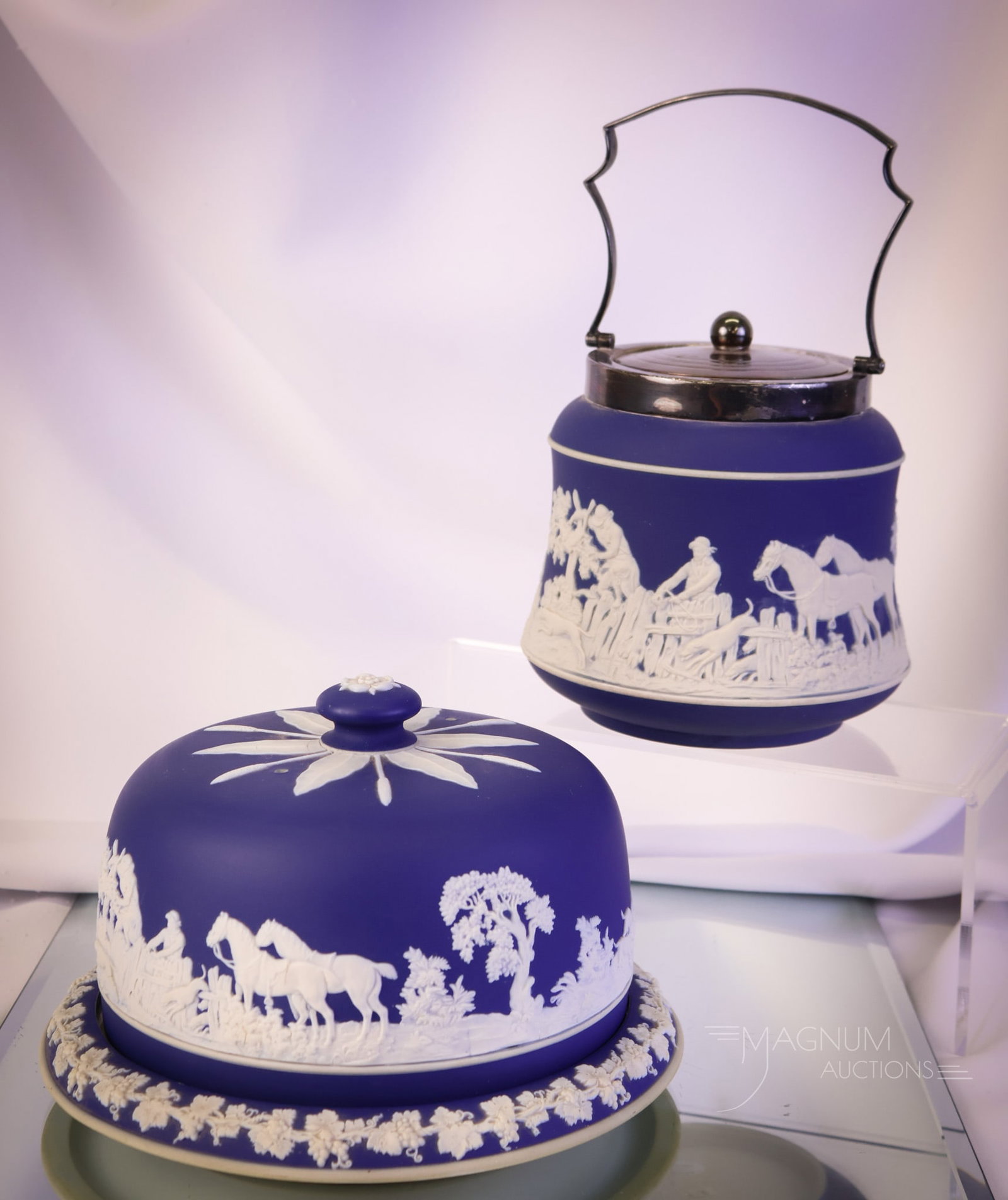 2 pc Lot Adams Tunstall Blue Jasperware Cheese Dish and Biscuit Jar: Two attractive finds in blue Jasperware by Adams Tunstall. This lot combines a biscuit jar with a silverplate rim and handle, along with a cheese dish. The tallest measures 6". SHIPPING NOTICE: If you