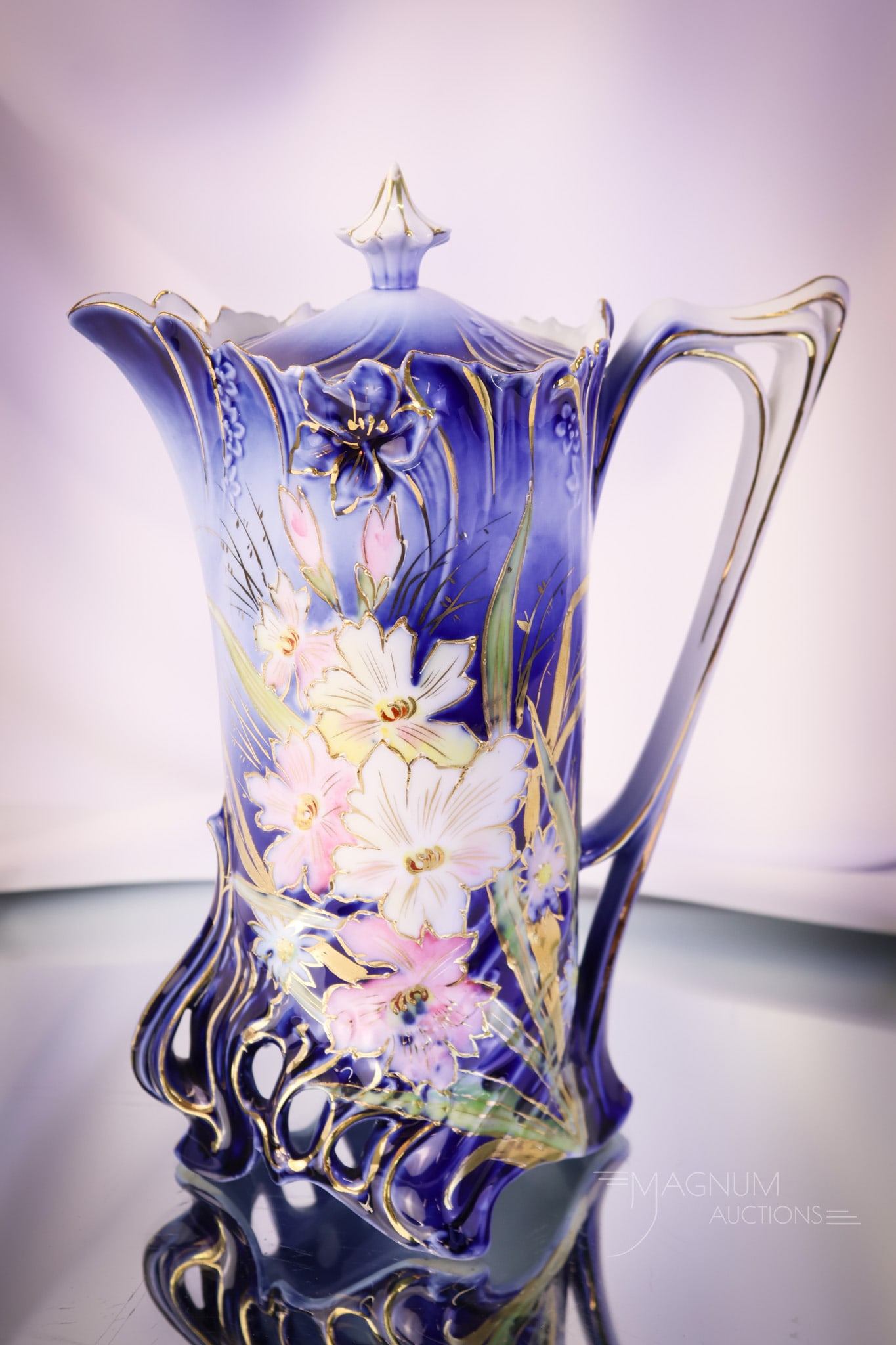 R.S. Prussia Cobalt Floral Chocolate Pot: A stiking unmarked R.S. Prussia porcelain chocolate pot. This piece features pink and white florals with gold. The pot measures 9" tall. SHIPPING NOTICE: If you choose not to utilize the LiveAuctionee