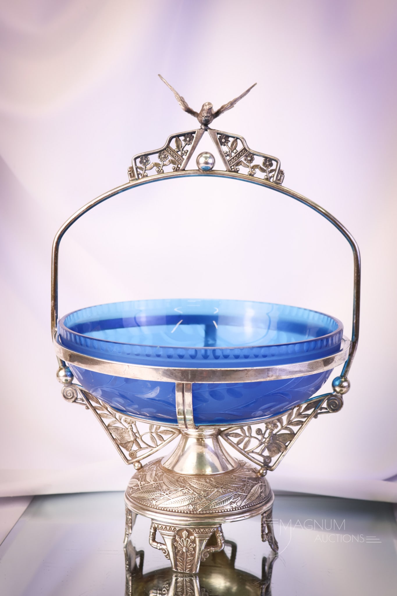 Pairpoint Silverplate Victorian Brides Basket Bowl Centerpiece: A beautiful signed Pairpoint silverplate brides' bowl basket centerpiece. This holder features a bird on the top of the handle. The bowl is a celeste blue with a satin finish and floral cutting. The b