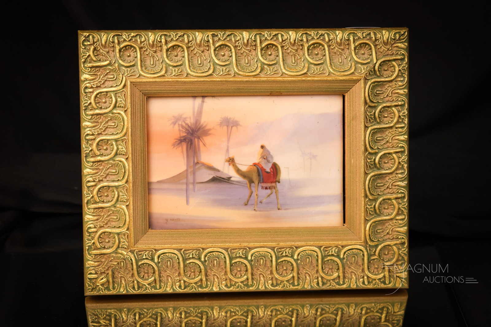 Green Mark Nippon Artist Signed Nippon Framed Desert Scene Plaque: A very nice find in this green mark Nippon frame wall plaque. This piece depicts a desert scene with a camel. The plaque is artist-signed. The plaque measures 4 1/2" by 3". The frame measures 7 3/4" b
